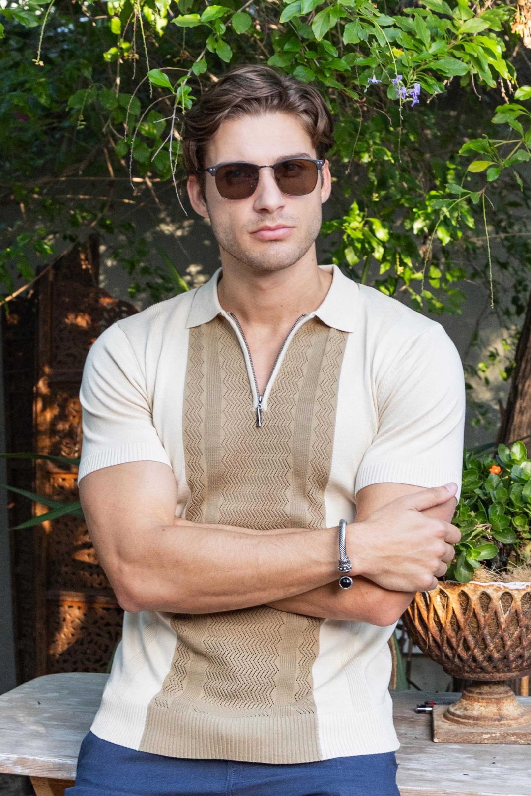 Men sitting wearing a Knit Polo Shirt outdoor.