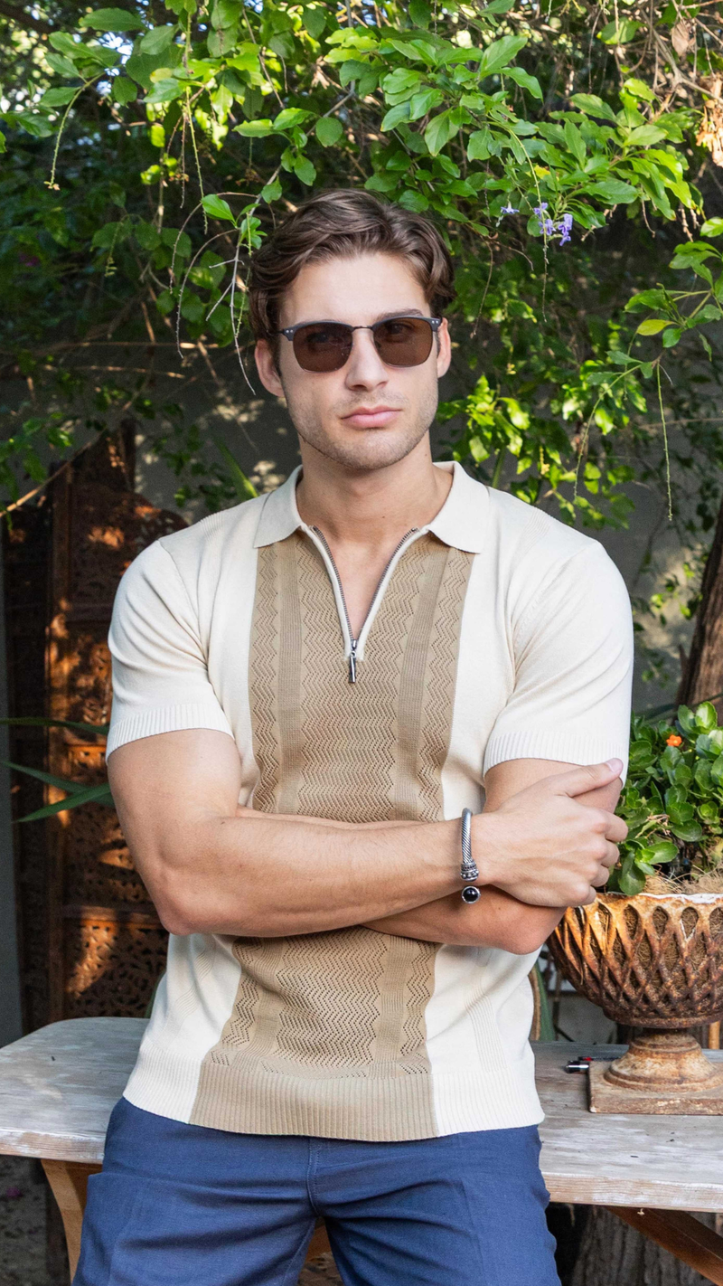 Men sitting wearing a Knit Polo Shirt outdoor.