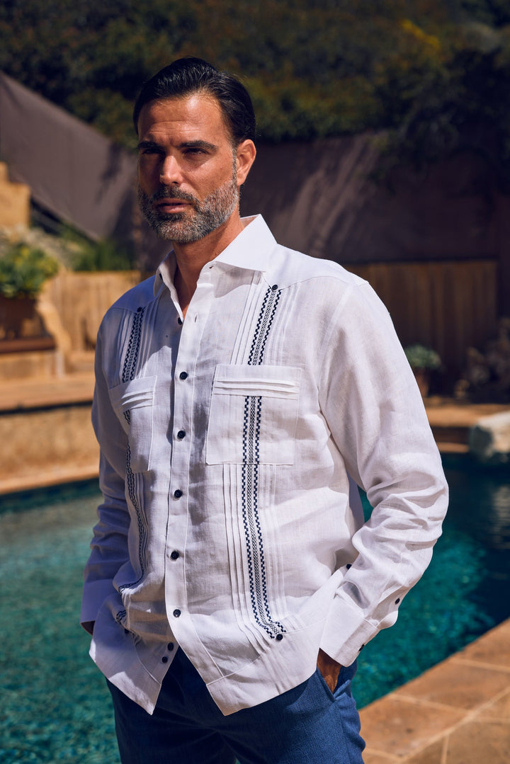 Front view of a man wearing the white 100% Linen Embroidery Trimmed Guayabera Long Sleeve shirt.