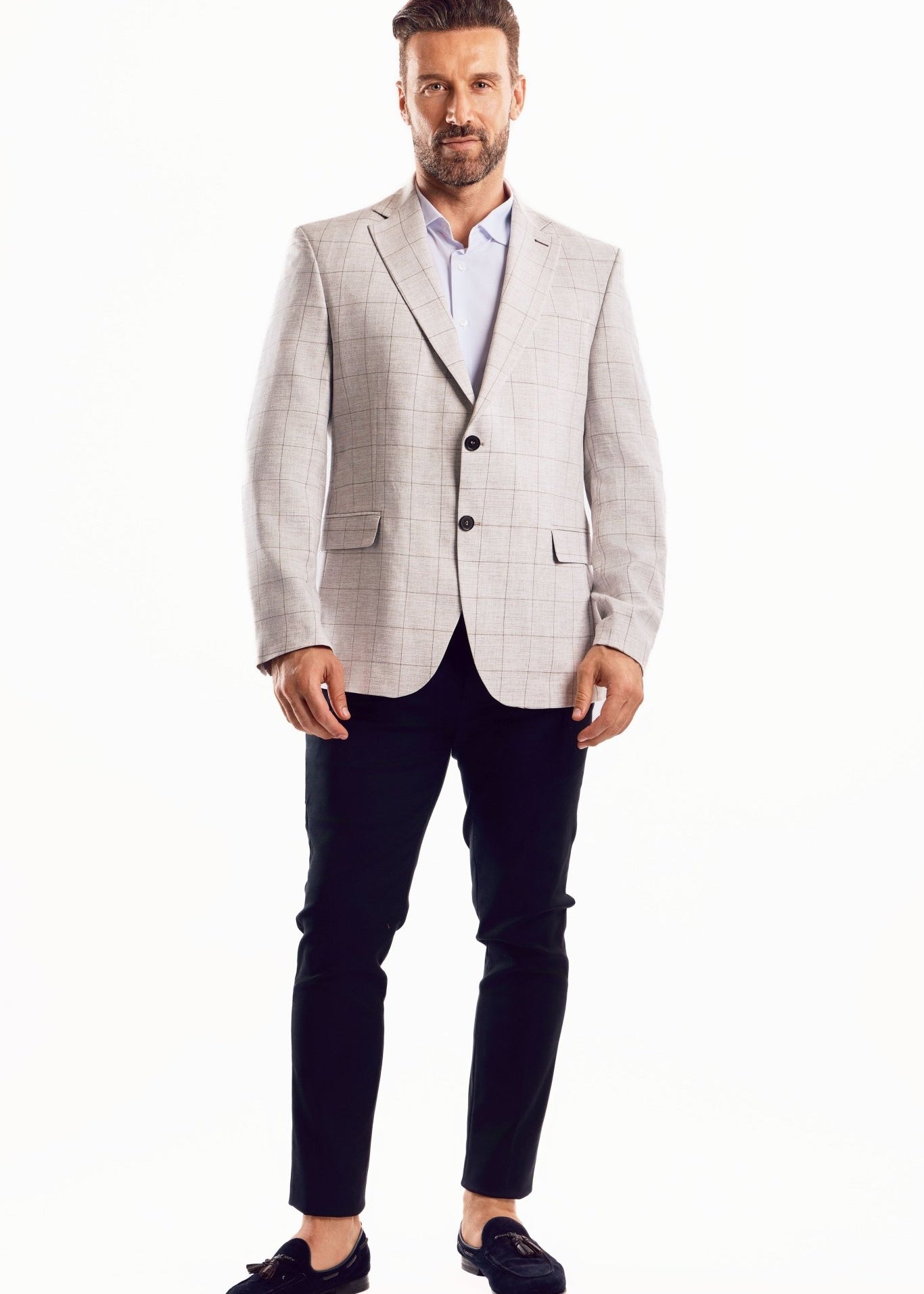 Full shot of a man wearing a Men's Light Checker Print Sports Jacket and black dress pants.