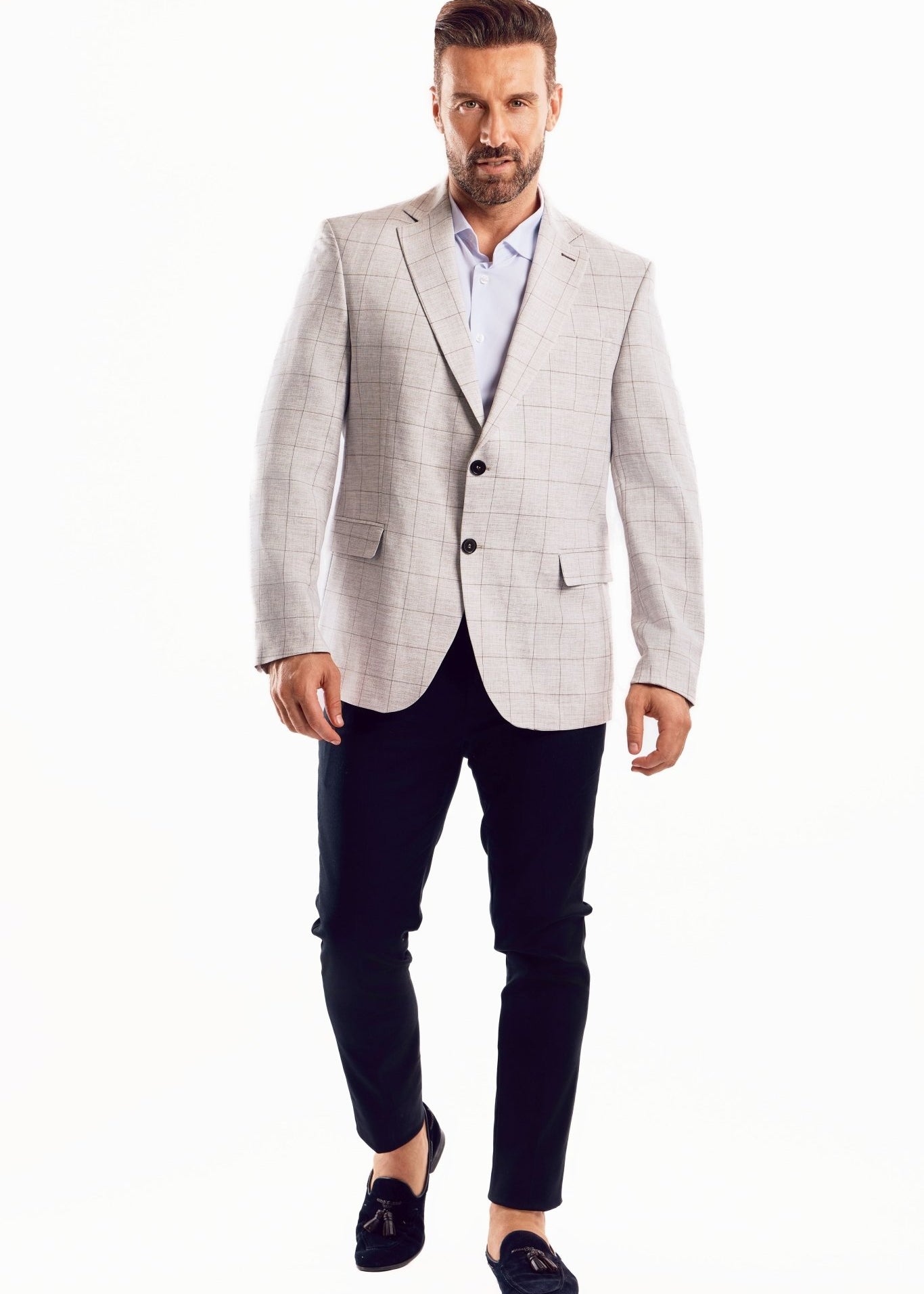 Full shot of a man wearing a Men's Light Checker Print Sports Jacket, black pants, and dark shoes.