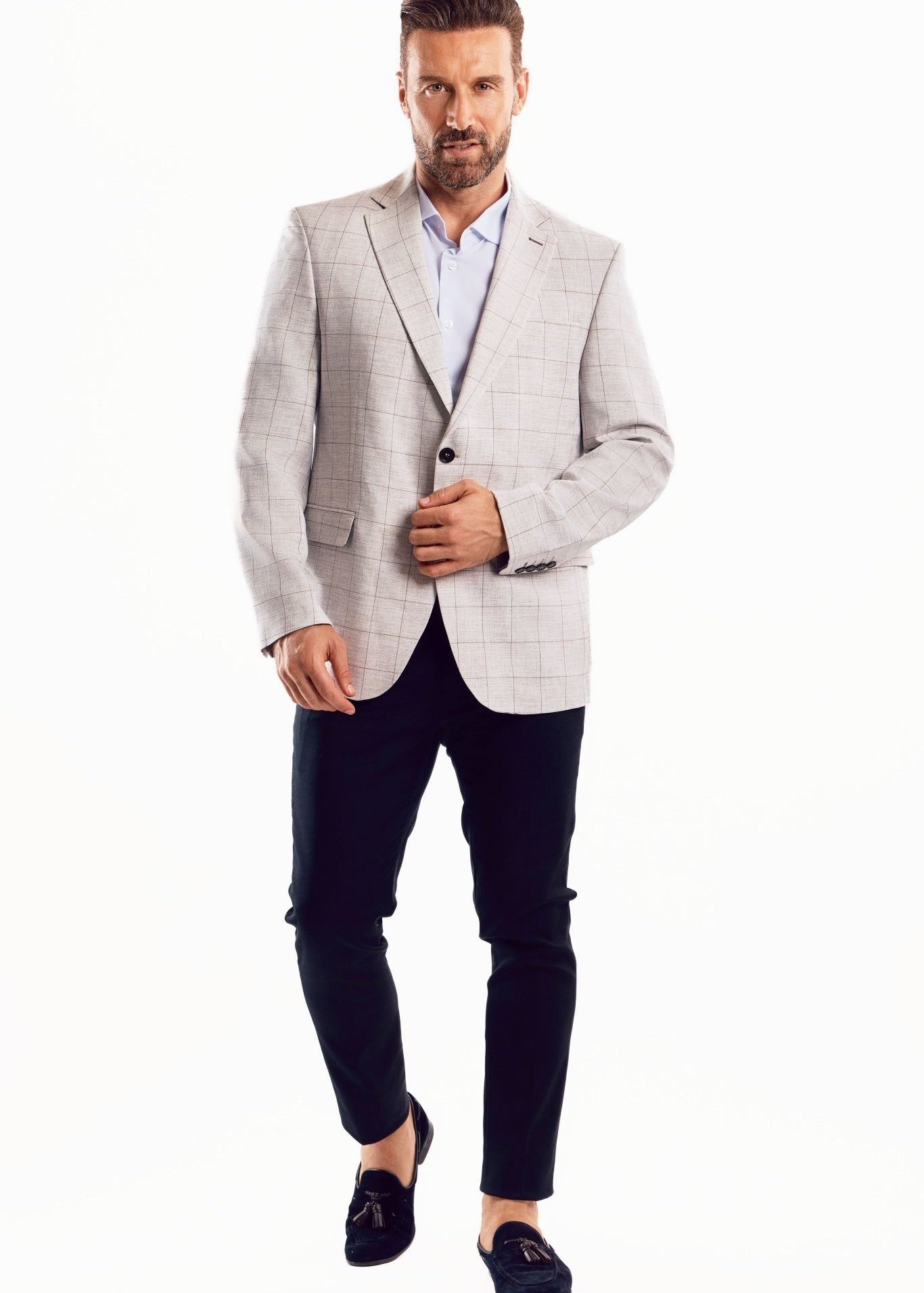 A man wears the light checker print sports jacket, shown from the front in a full body shot.