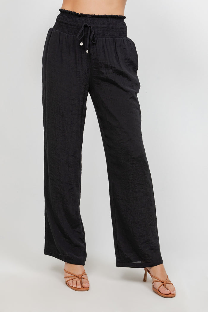 Front view of Ladies Smocked Waist Drawstring Palazzo Pants in white, with smocked waist detail.