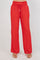 Front view of red Ladies Smocked Waist Drawstring Palazzo Pants featuring a smocked waist and wide legs.