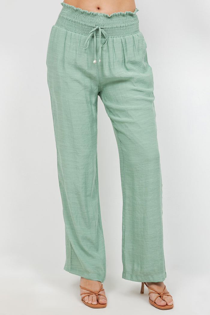 Front view of Ladies Smocked Waist Drawstring Palazzo Pants in white, with smocked waist detail.