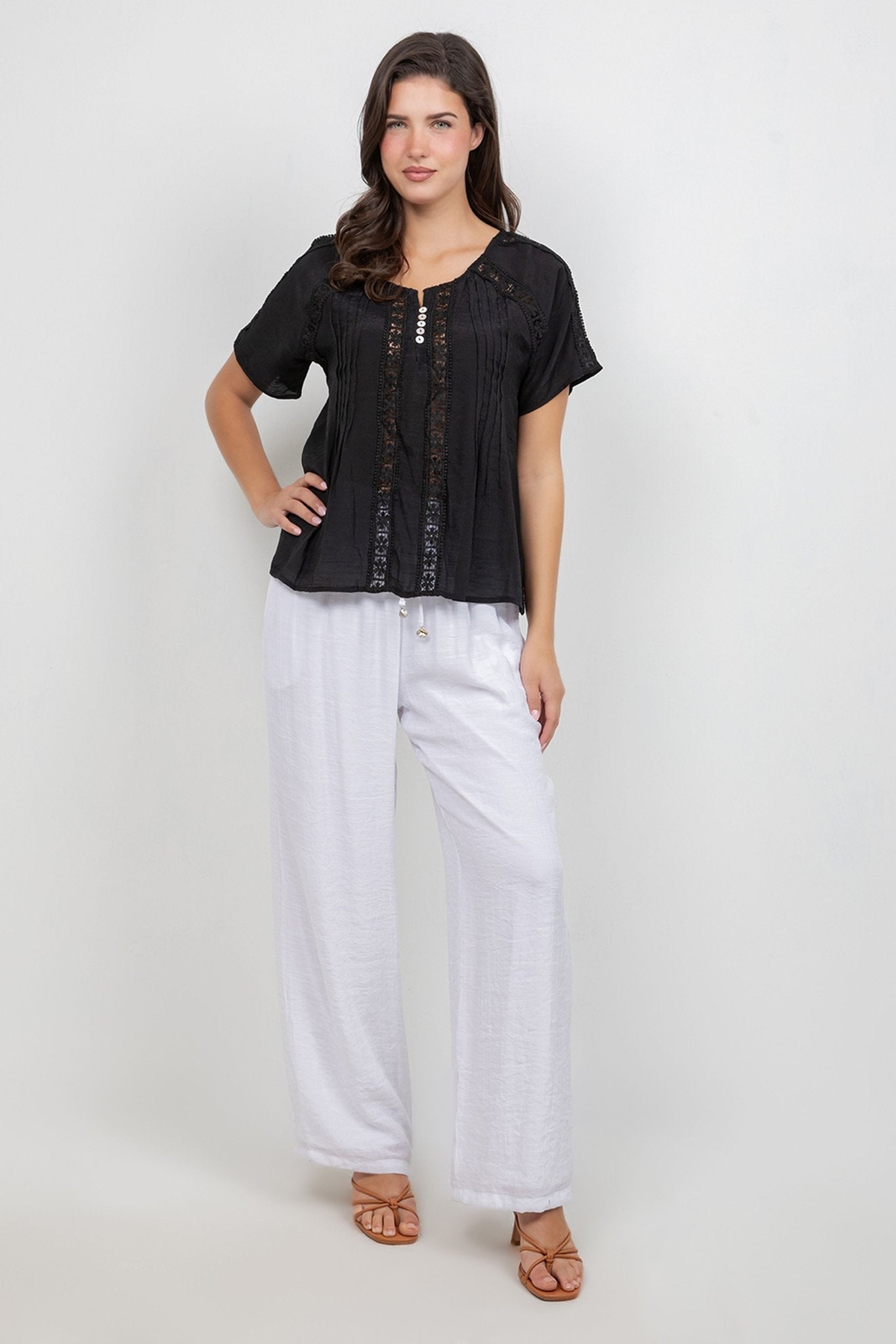 Front view of model wearing white Ladies Smocked Waist Drawstring Palazzo Pants.