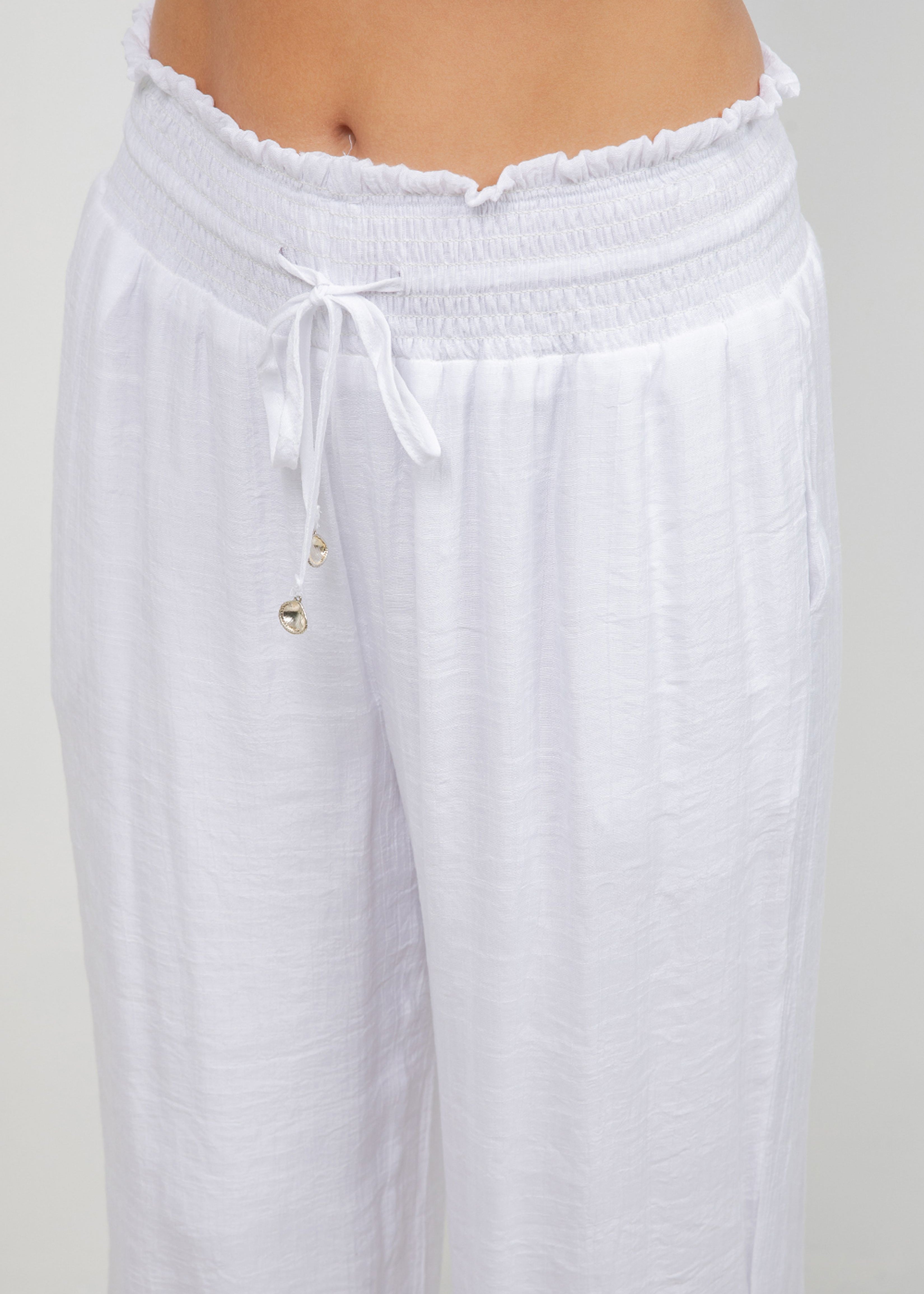 Close-up of white Ladies Smocked Waist Drawstring Palazzo Pants at the waist with tie detail.