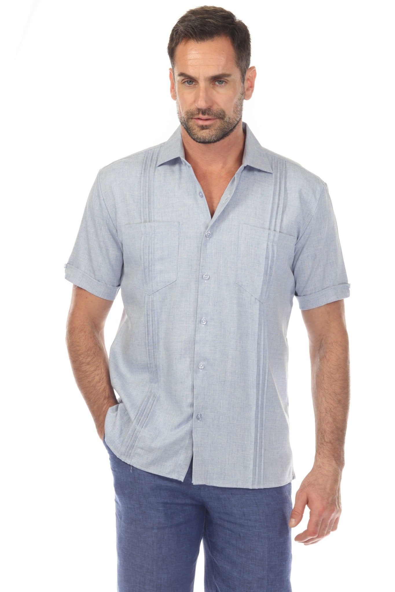 Front view of a man wearing a light blue Men’s Classic Two-Pocket Guayamisa Shirt with Pleats.
