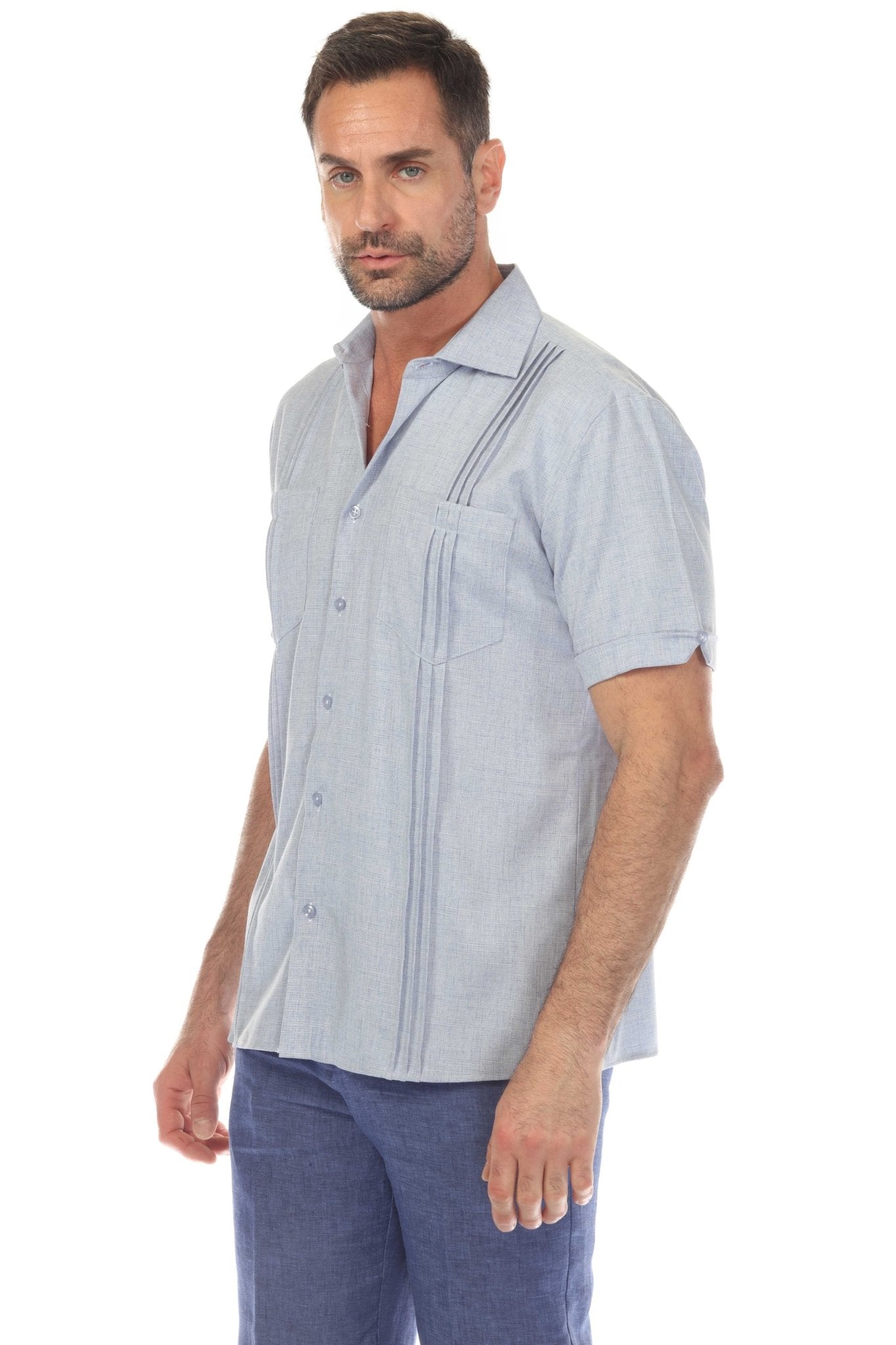 Man wearing a light blue Men’s Classic Two-Pocket Guayamisa Shirt, shown from the side, detailing the pleats.