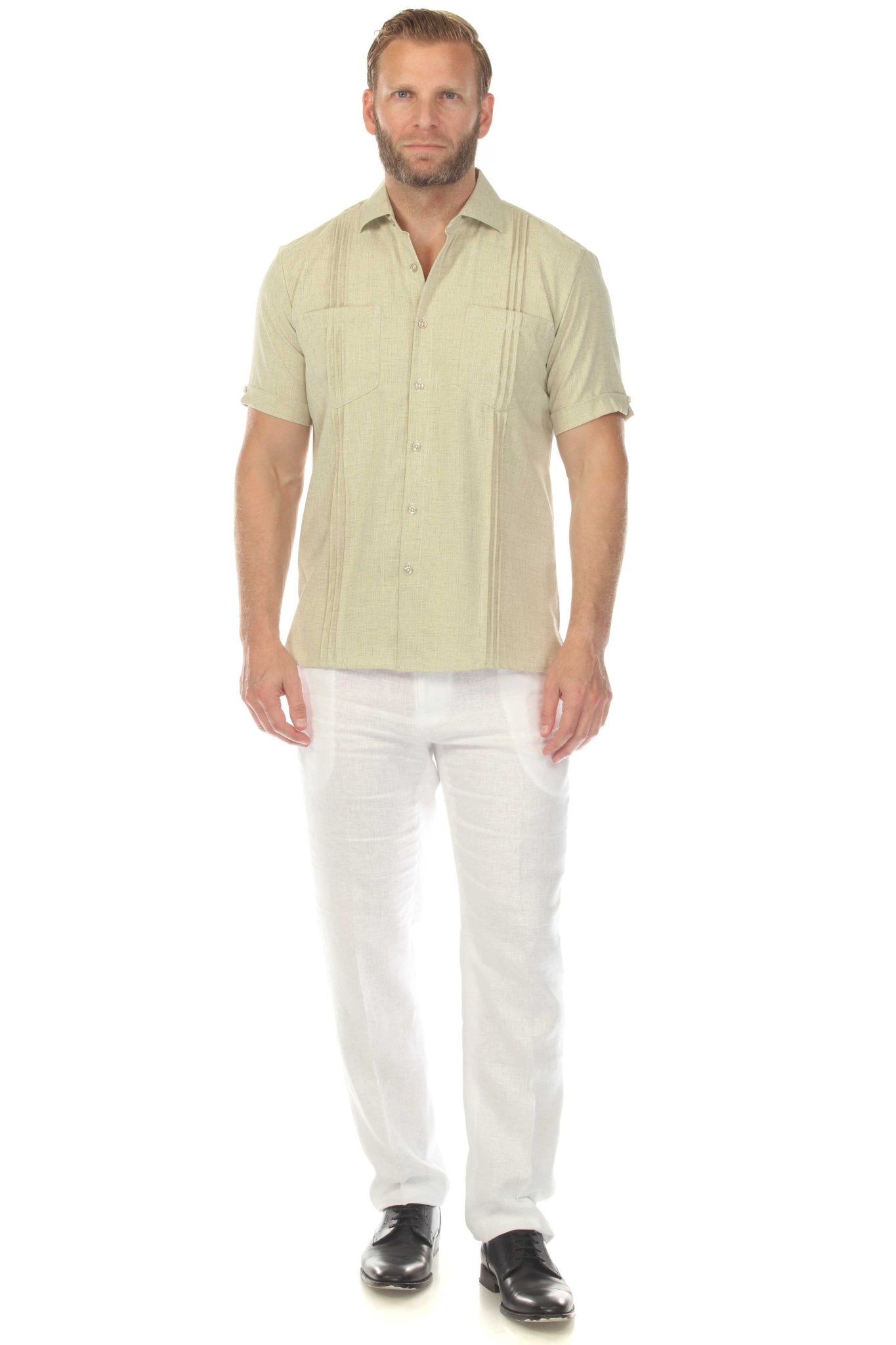 Front view of a man wearing a tan Men’s Classic Two-Pocket Guayamisa Shirt with Pleats and white pants.