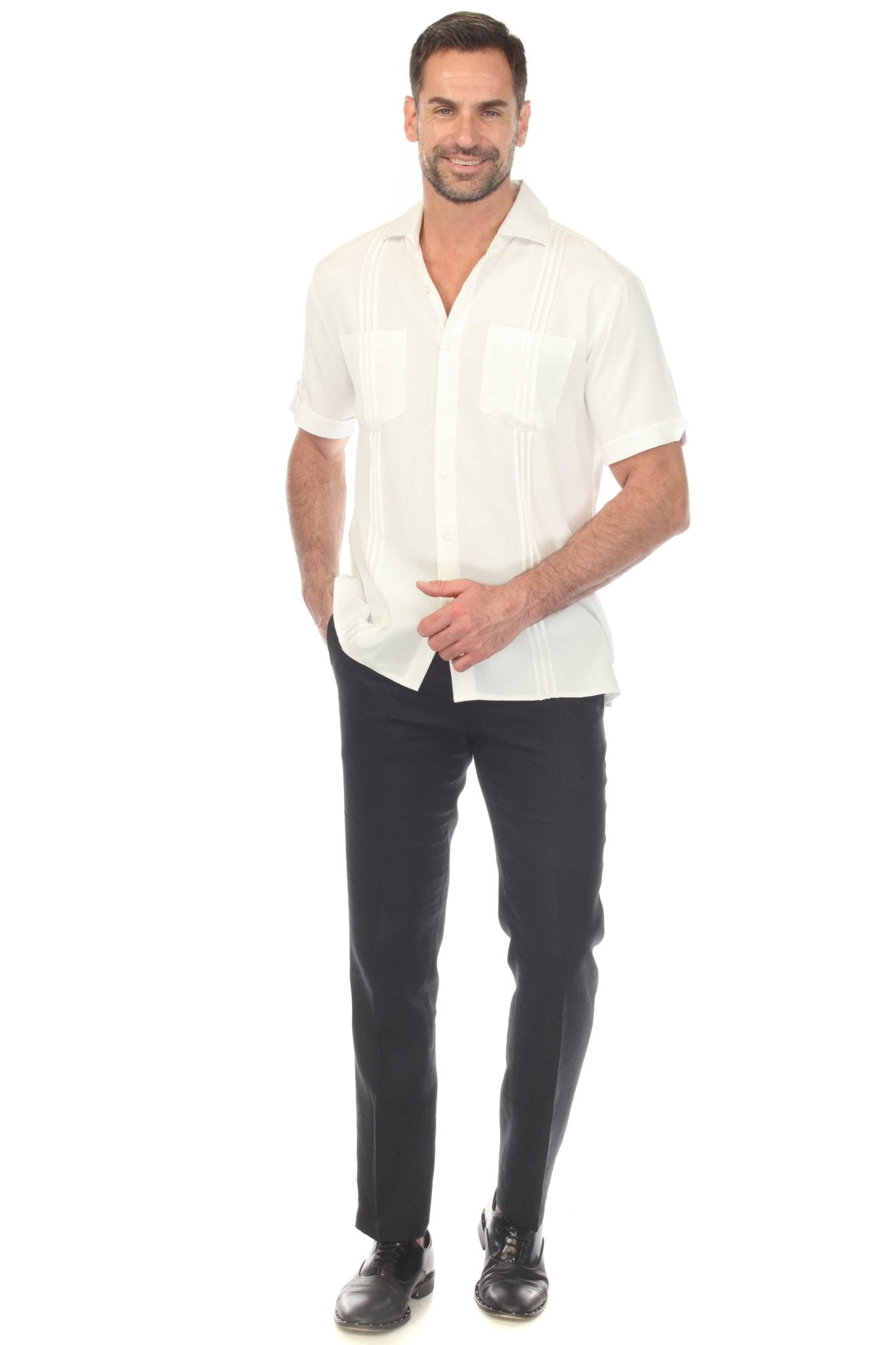 Front view of a man wearing a white Men’s Classic Two-Pocket Guayamisa Shirt with Pleats and black pants.