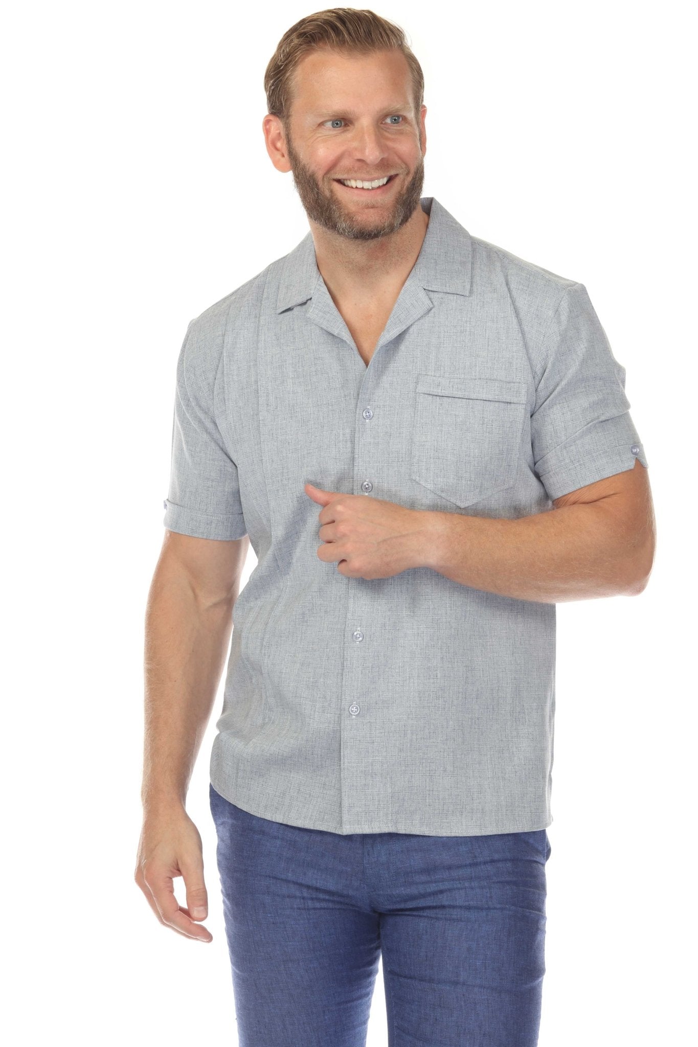 A man models a light gray Menâ€™s Retro Cuban Shirt featuring stylish pleating and a classic one-pocket design.