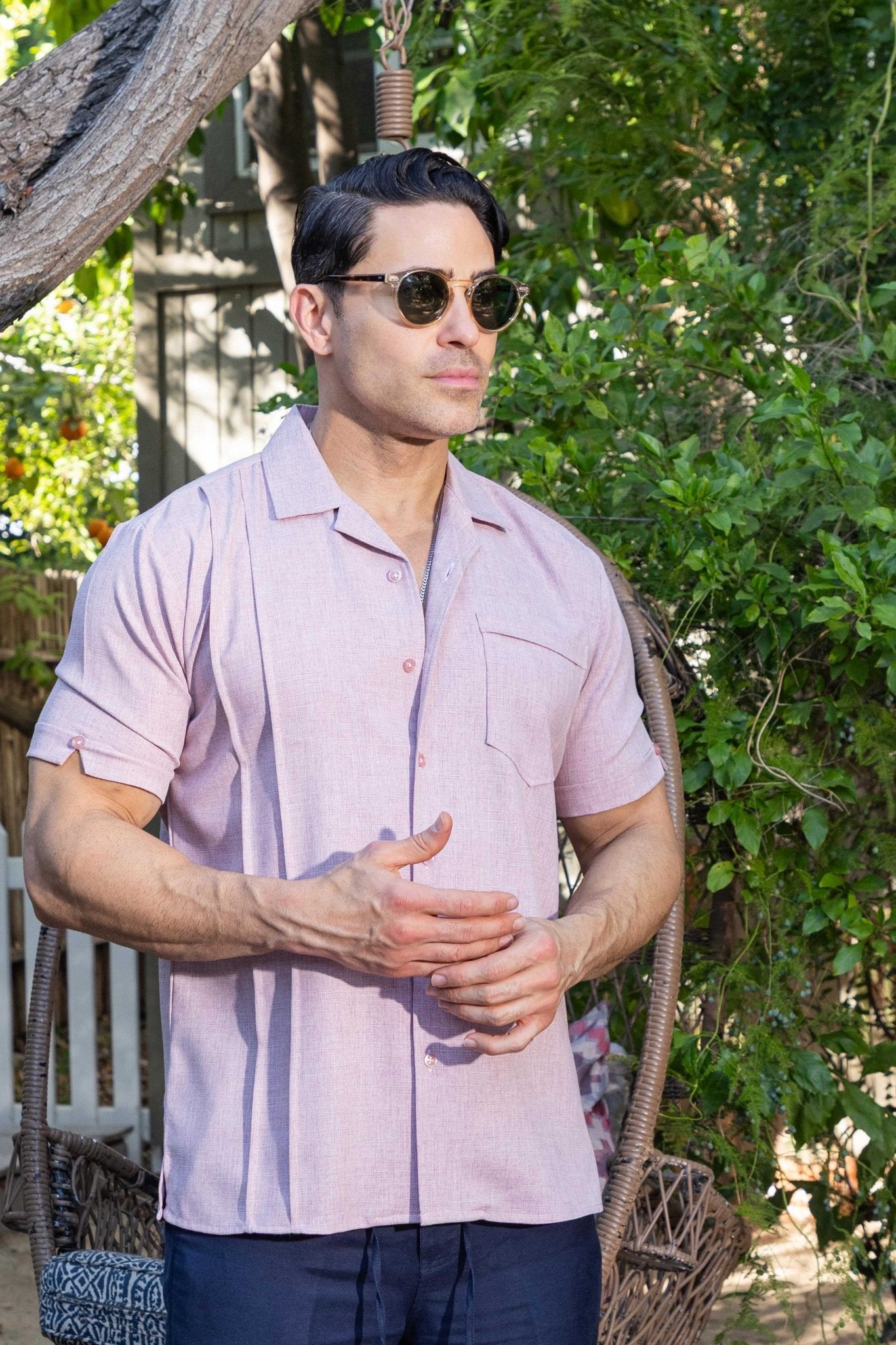 Man in the pink Menâ€™s Retro Cuban Shirt with pleating and one pocket.