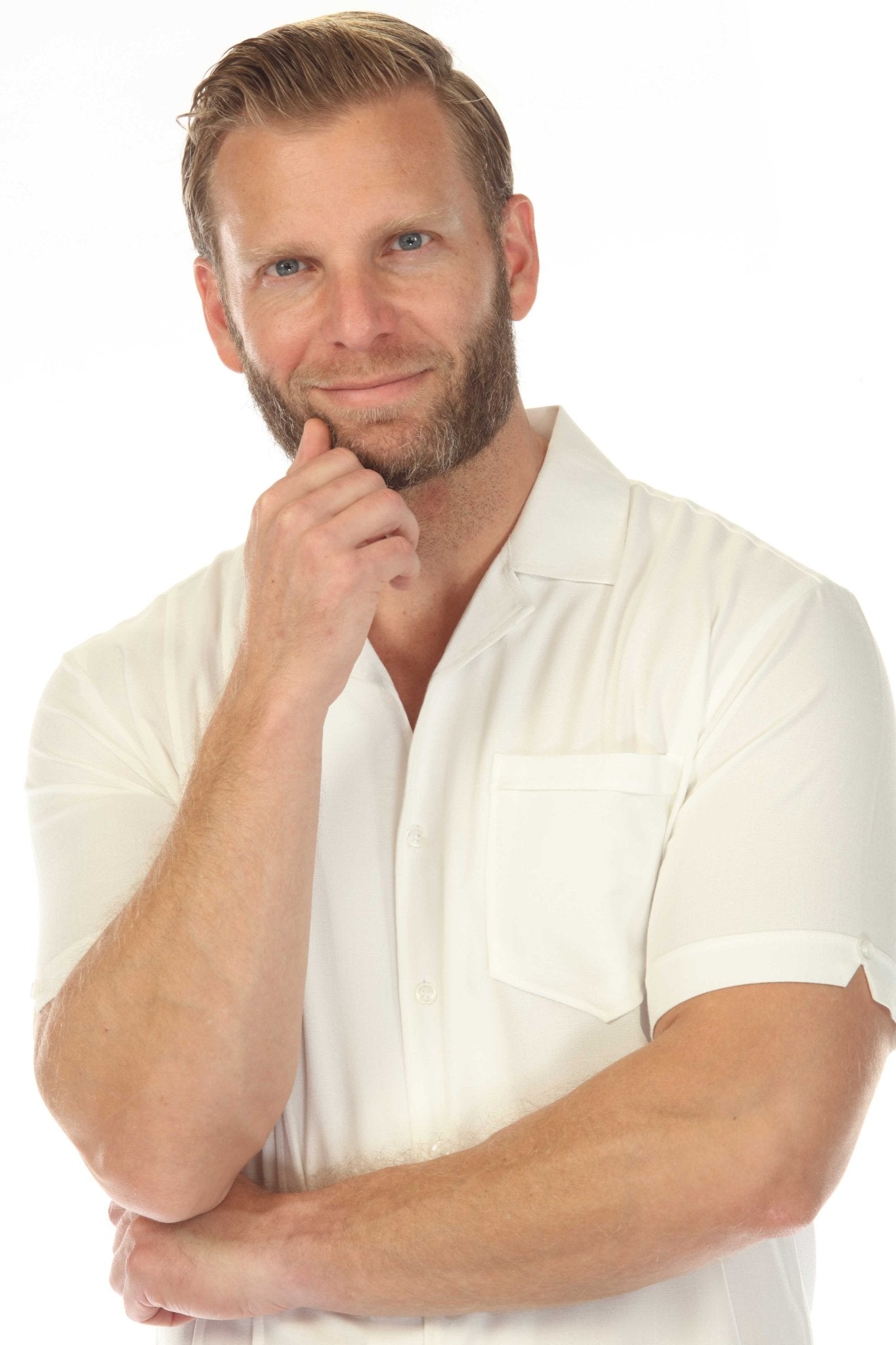 Man wearing the Menâ€™s Retro Cuban Shirt in white, showcasing the short sleeves and classic one-pocket design.