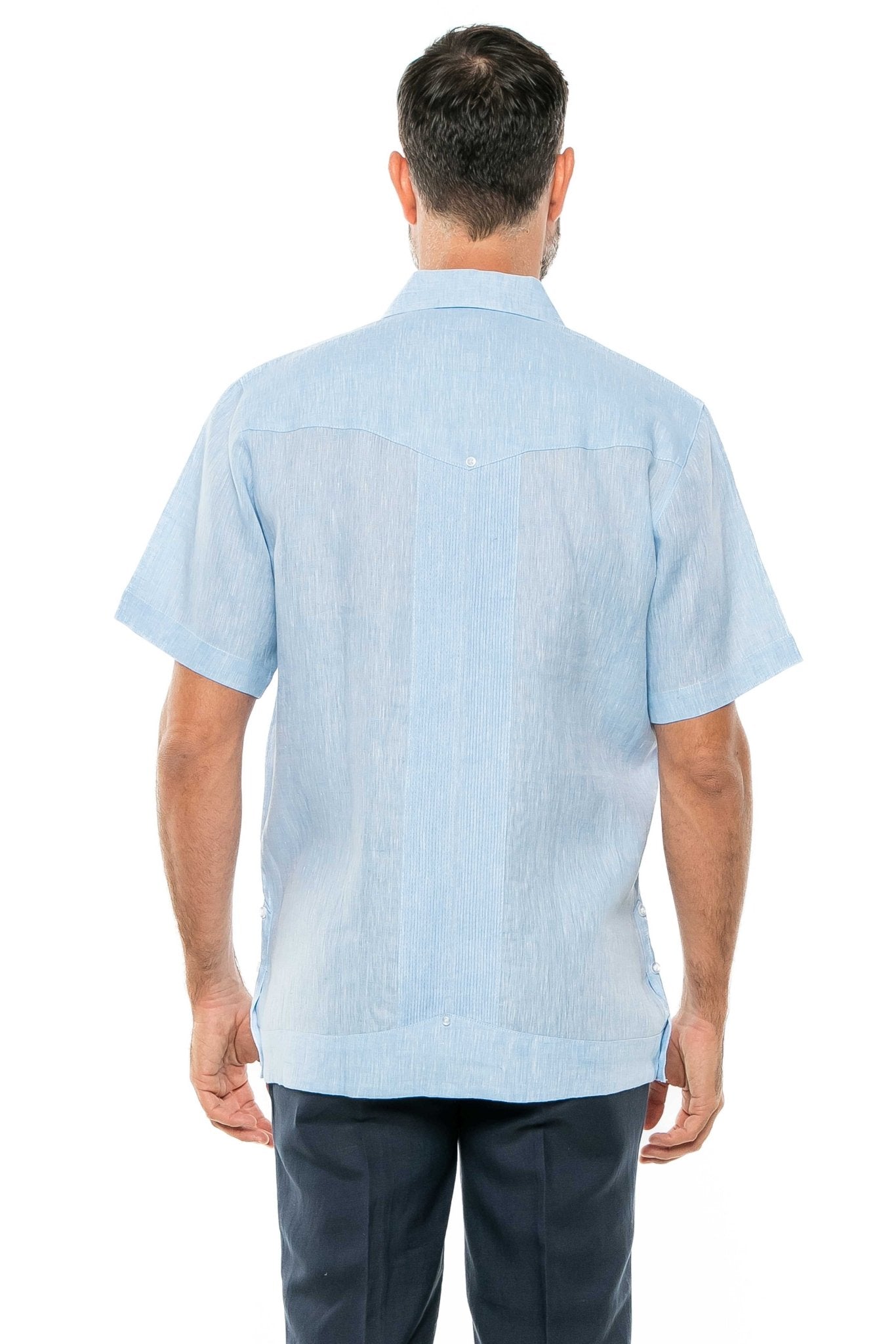 Back view of a man wearing a light blue Yarn Dye 100% Linen Two Pocket Guayabera Short Sleeve shirt.