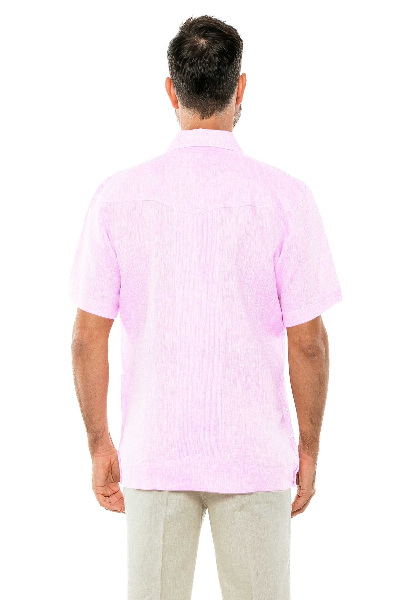 Back view of a man wearing a pink Yarn Dye 100% Linen Two Pocket Guayabera Short Sleeve shirt and neutral slacks.