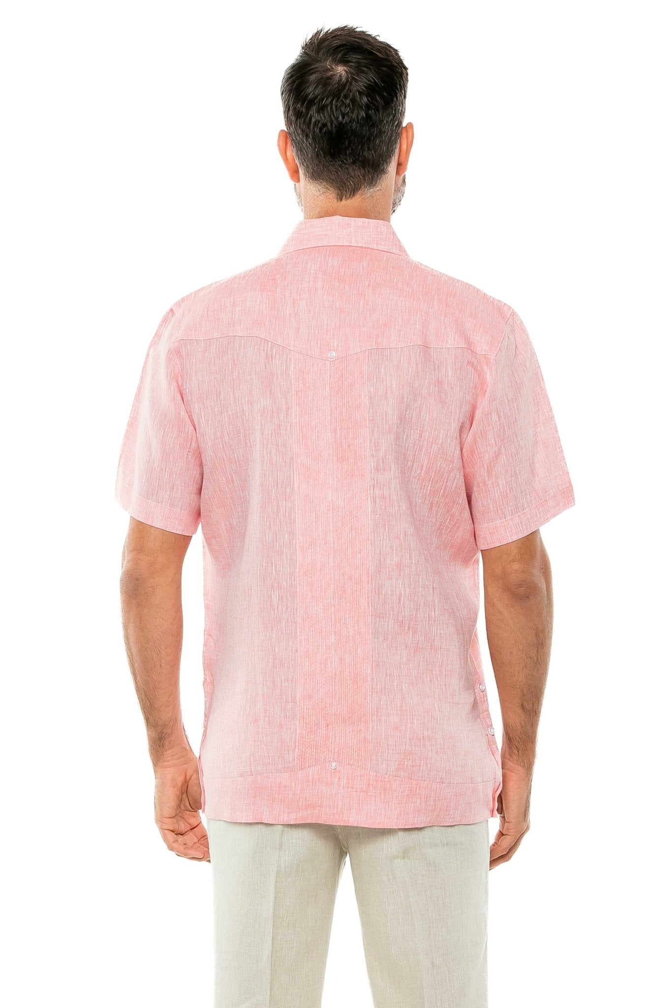 Back view of a man wearing a pink Yarn Dye 100% Linen Two Pocket Guayabera Short Sleeve shirt, showing the yoke detail.
