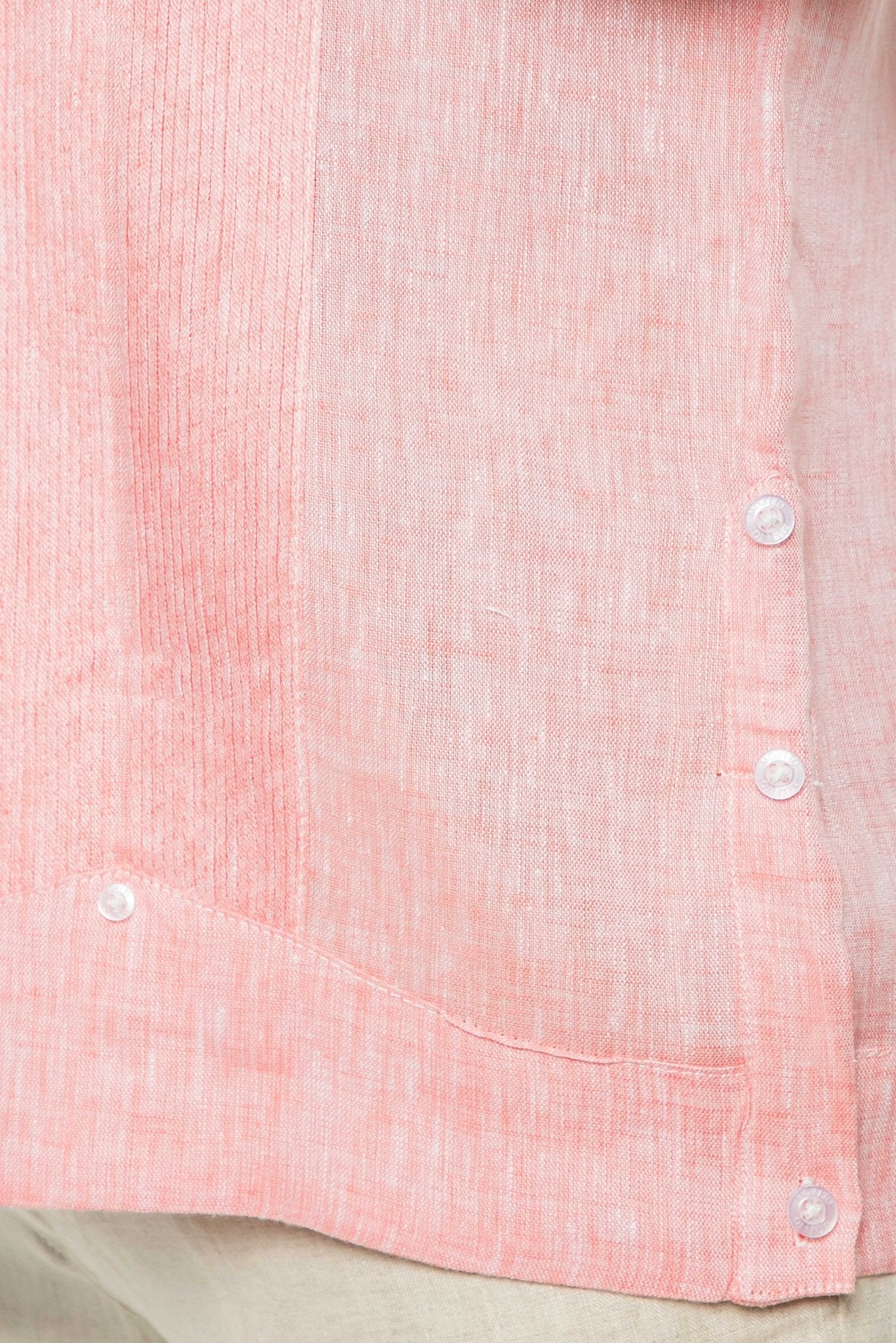 Close up of light red Yarn Dye 100% Linen Two Pocket Guayabera Short Sleeve shirt, showing the fabric texture, stitching and buttons.