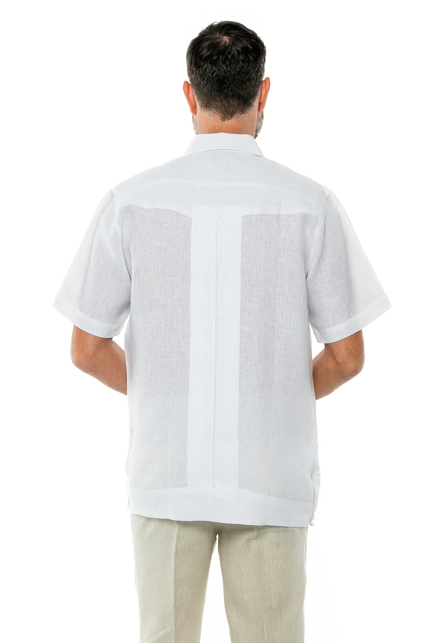 Back view of a person wearing a white Yarn Dye 100% Linen Guayabera Short Sleeve shirt, with linen panels.