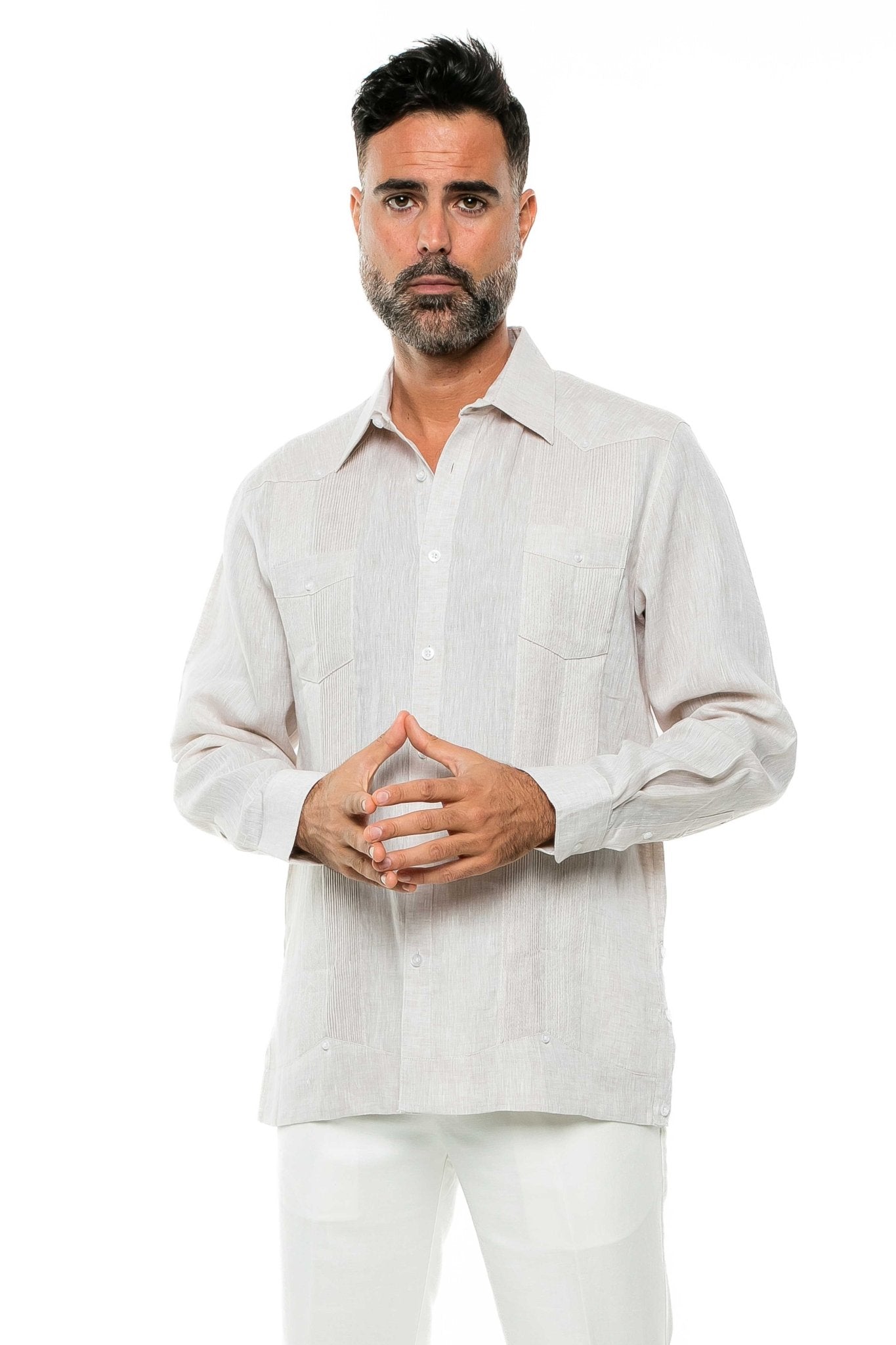 A man models the 100% Linen Yarn Dyed Two Pocket Guayabera Shirt Long Sleeve, shown in light beige with two chest pockets.