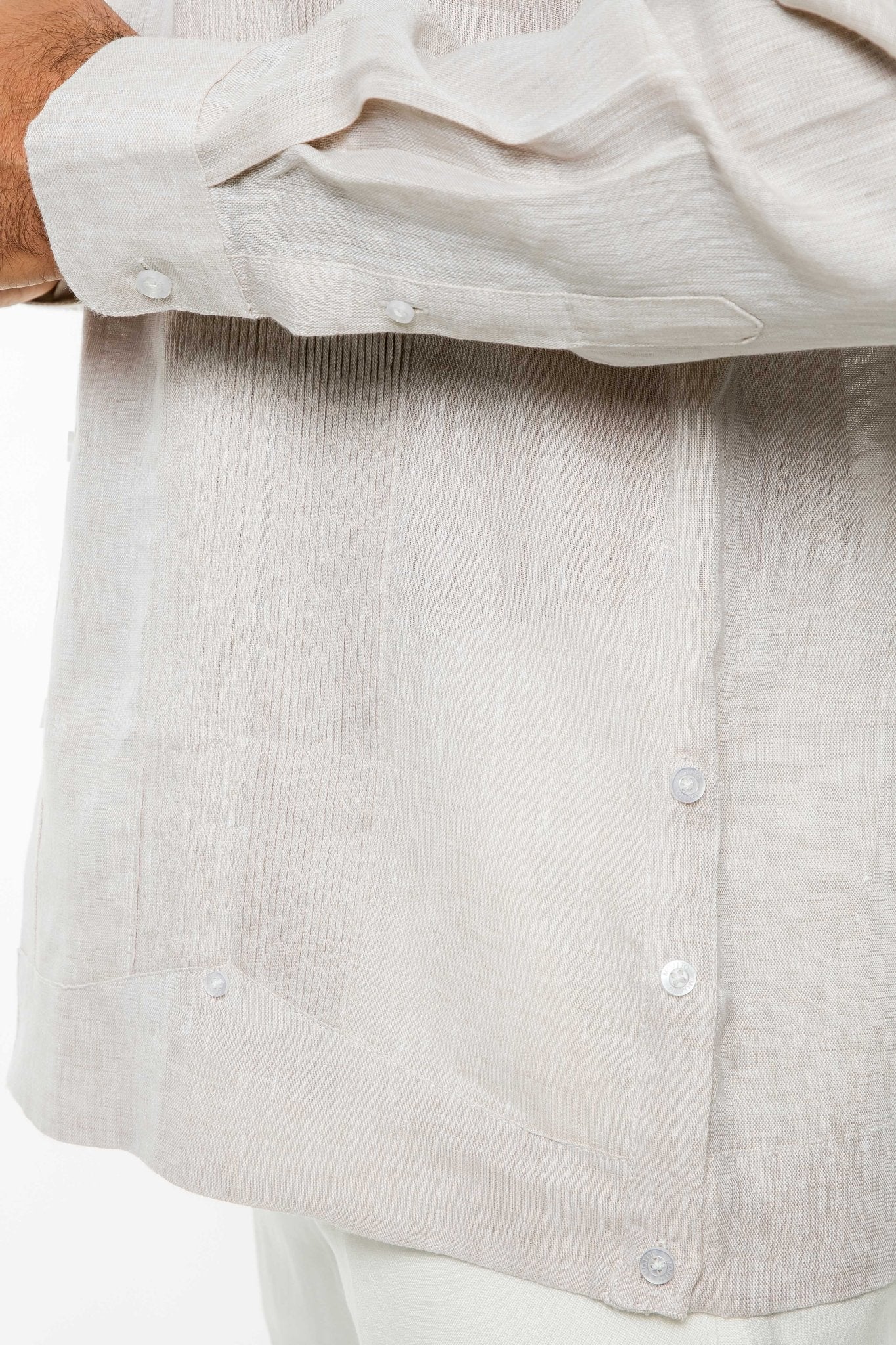 Close-up of a tan, long-sleeve 100% Linen Yarn Dyed Two Pocket Guayabera Shirt showing the pockets, vertical pleats, and buttons.