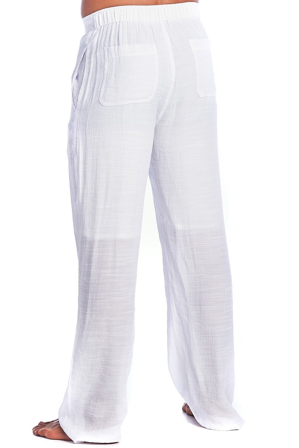 White wide-leg cotton gauze pants with an elastic waistband and side pockets, shown on a model from the back against a white background.