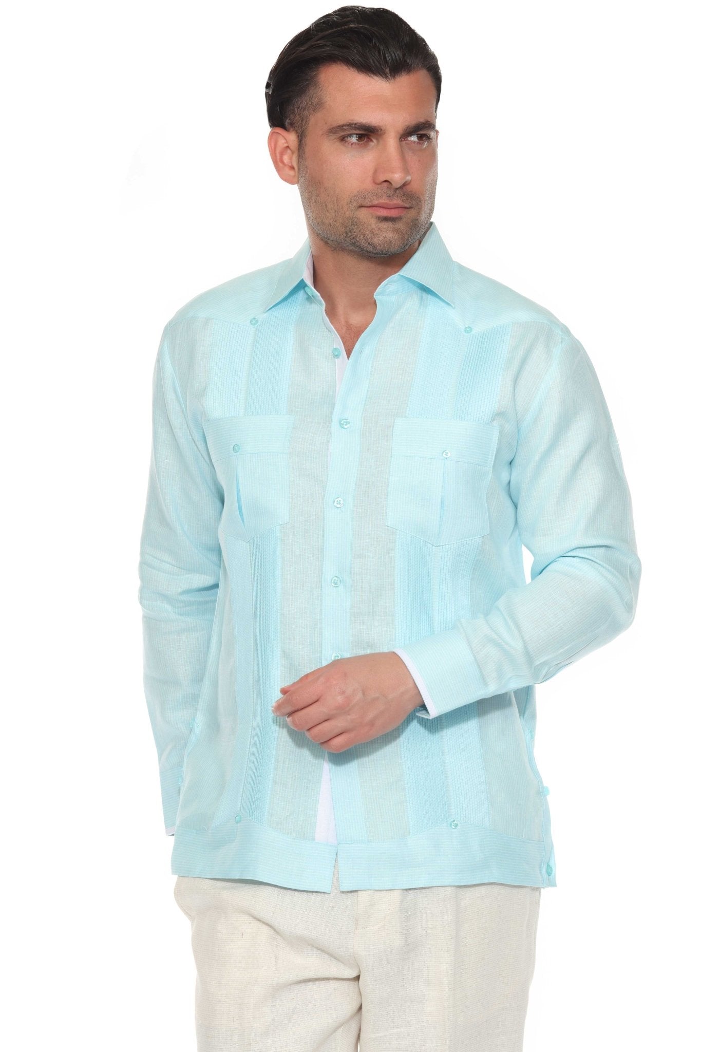 A man wears a light blue 100% Linen Contrast Panel Guayabera Shirt Long Sleeve, buttoned up.