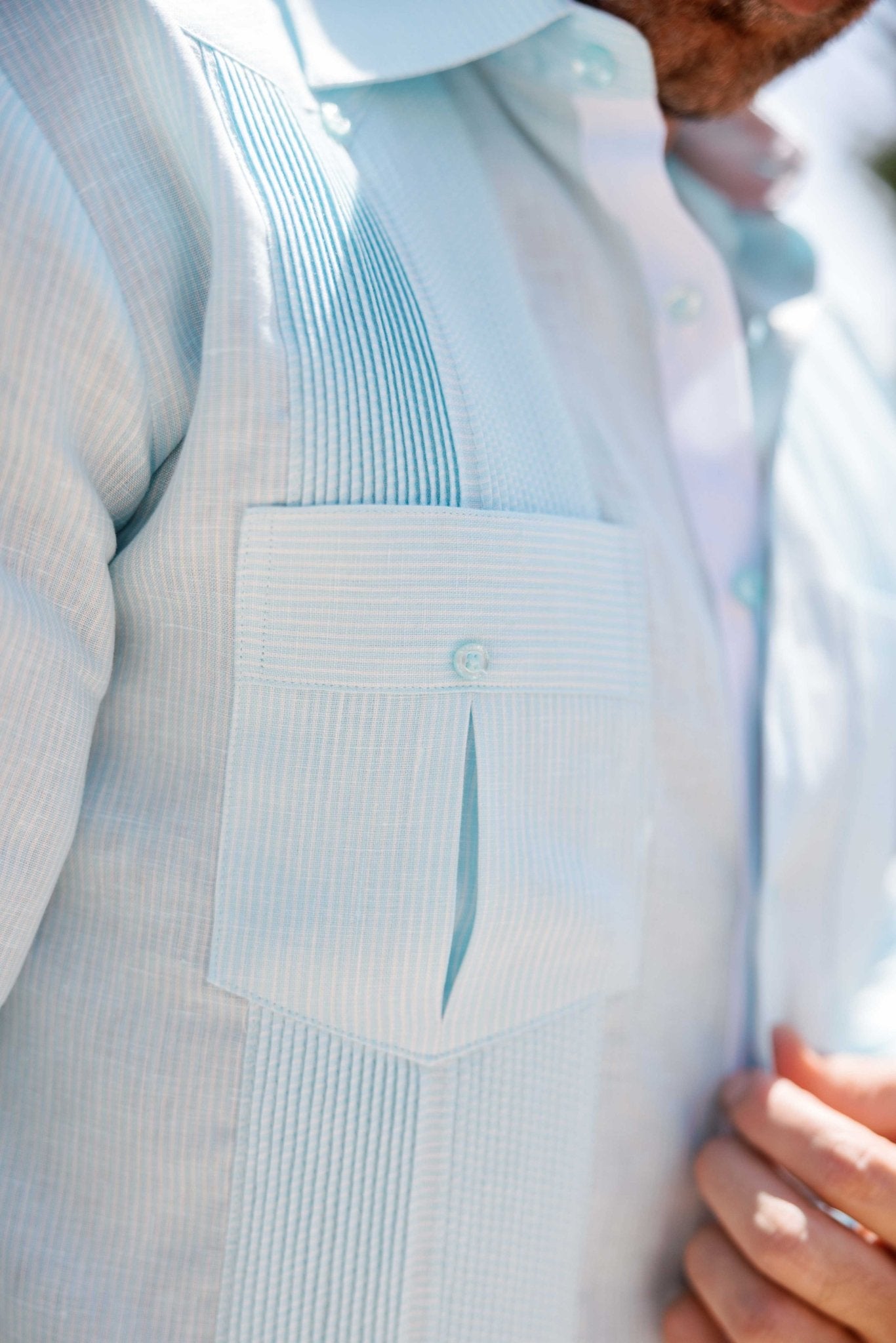 Close-up of a light blue 100% Linen Contrast Panel Guayabera Shirt Long Sleeve, showing detailed contrast paneling.