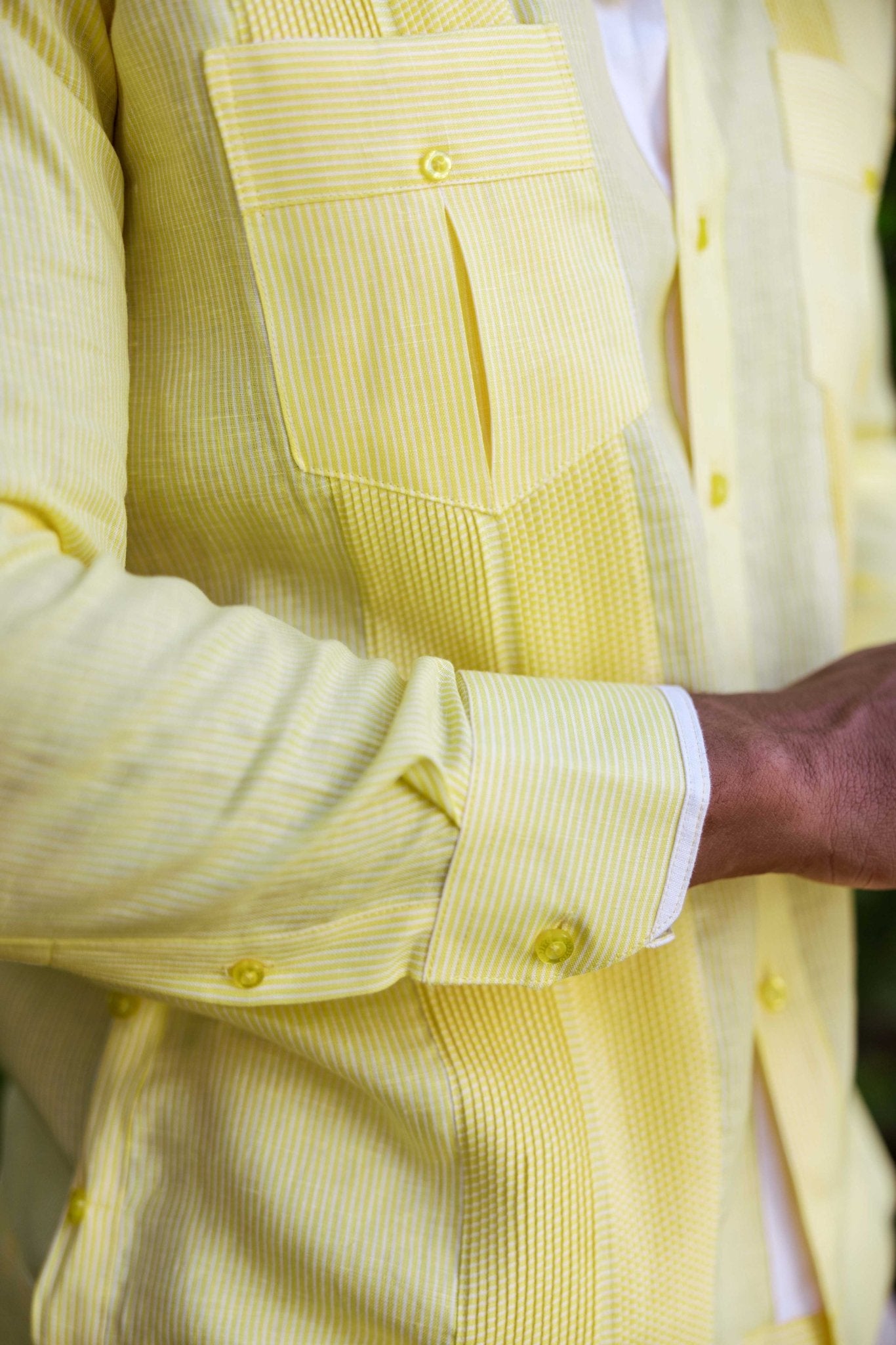 Close up of long sleeve, yellow and white striped 100% Linen Contrast Panel Guayabera Shirt detail, showing front panels.