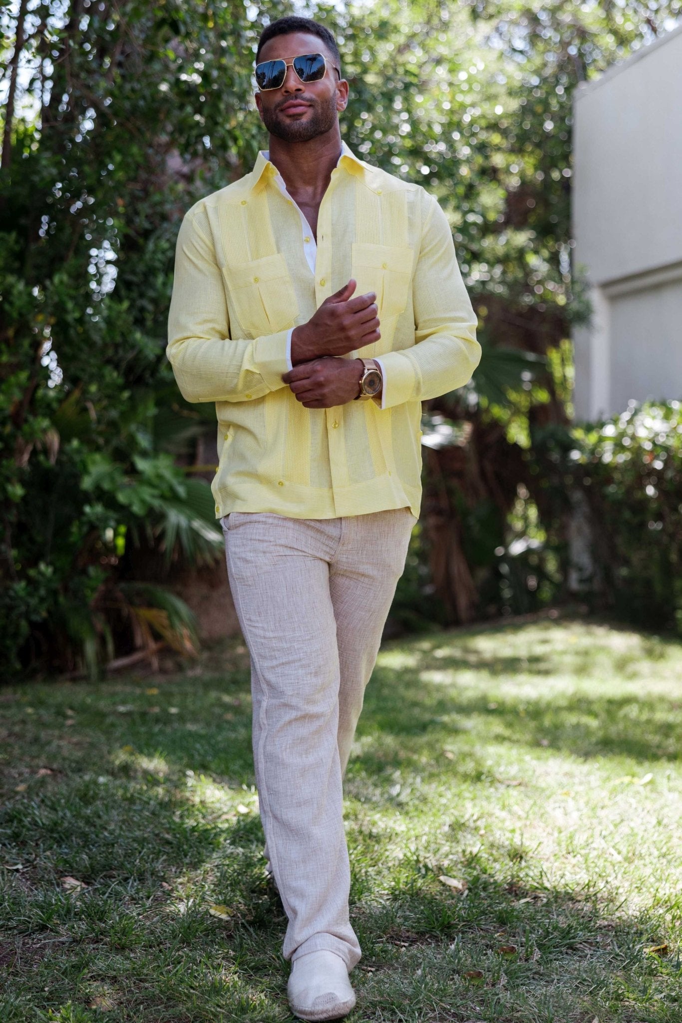 Front view of a man wearing a yellow long sleeve 100% Linen Contrast Panel Guayabera Shirt.