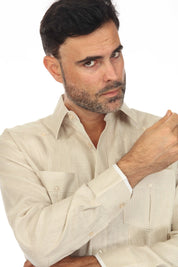 Close-up of a man wearing a tan 100% Linen Contrast Panel Guayabera Shirt with long sleeves.