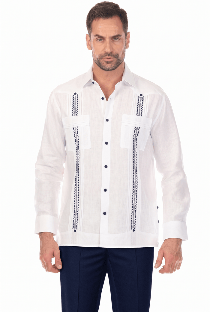 A man poses wearing a white 100% Linen Embroidery Trimmed Guayabera Long Sleeve with brown stitched detail.