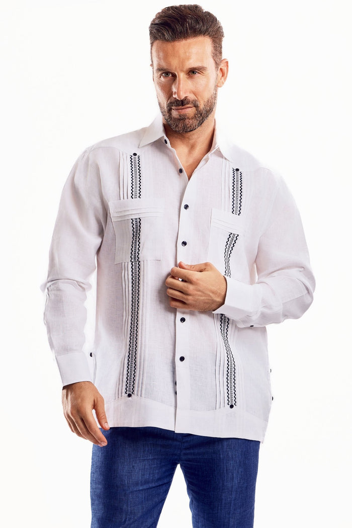 A man poses wearing a white 100% Linen Embroidery Trimmed Guayabera Long Sleeve with brown stitched detail.