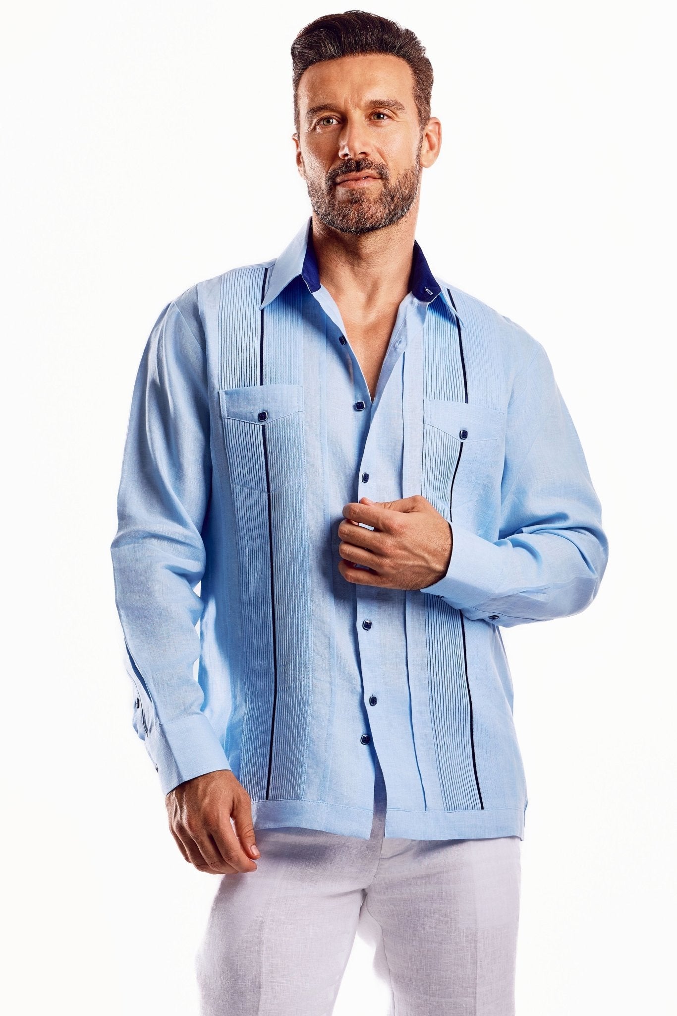Man in a blue linen guayabera shirt with contrast trim detail and long sleeves.