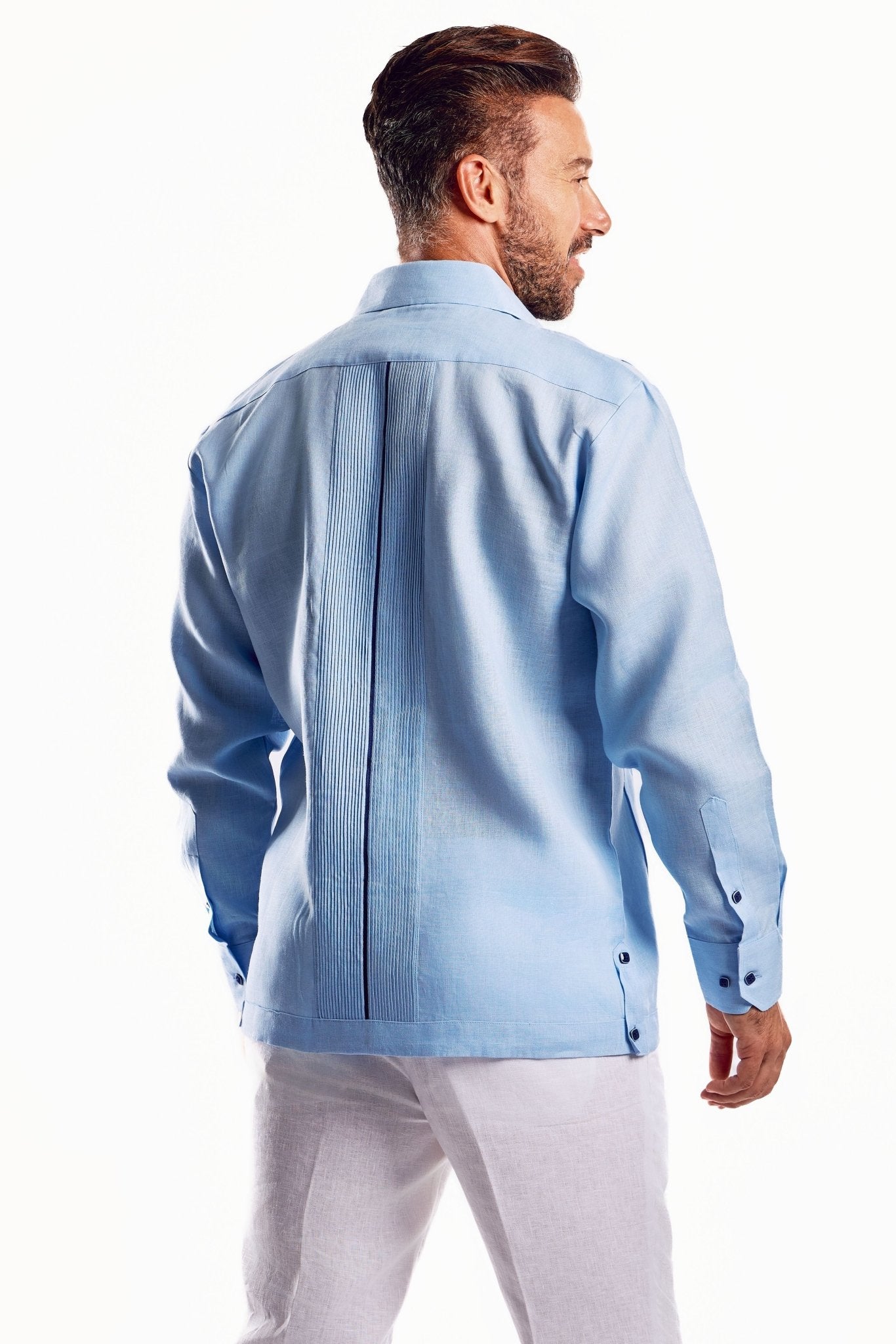 Back view of a light blue, long-sleeved men's linen Guayabera shirt with dark trim detail.