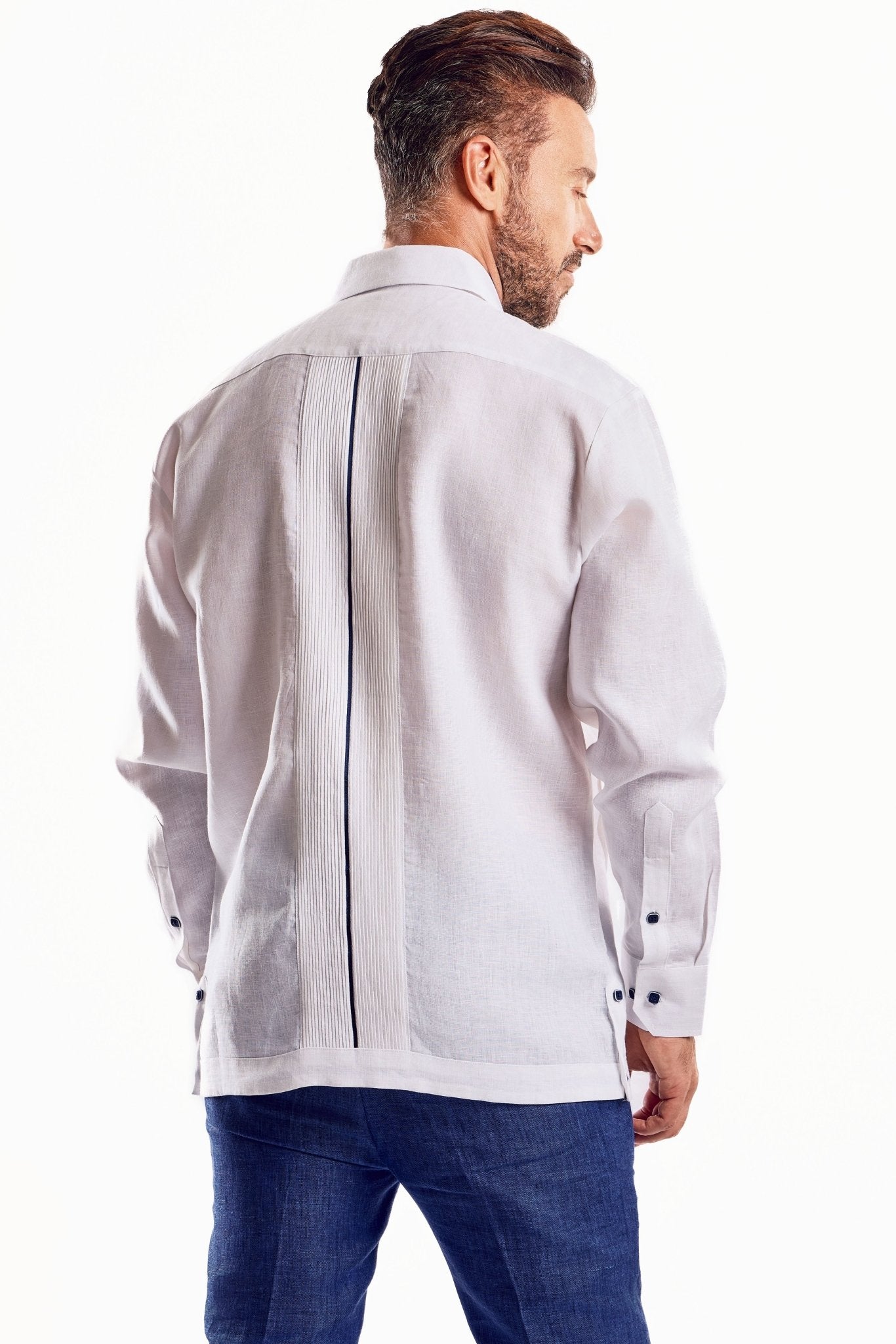 Back view of a man wearing the white Men's Linen Plus Size Guayabera shirt with long sleeves & contrast trim.