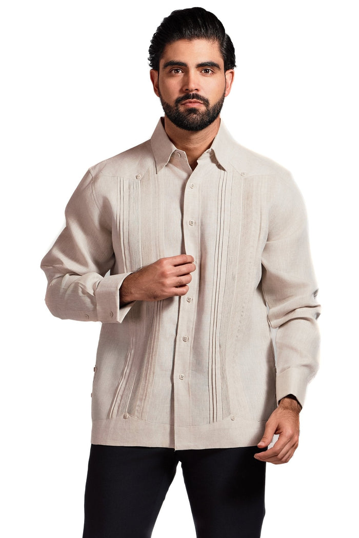 A man adjusting the cuff of a beige Men's Linen Formal Guayabera Long Sleeve Pleated Shirt.