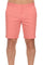 Close-up of a person wearing coral Men’s Dri-Fit Stretch Performance Shorts, shown from the waist down to the knees.