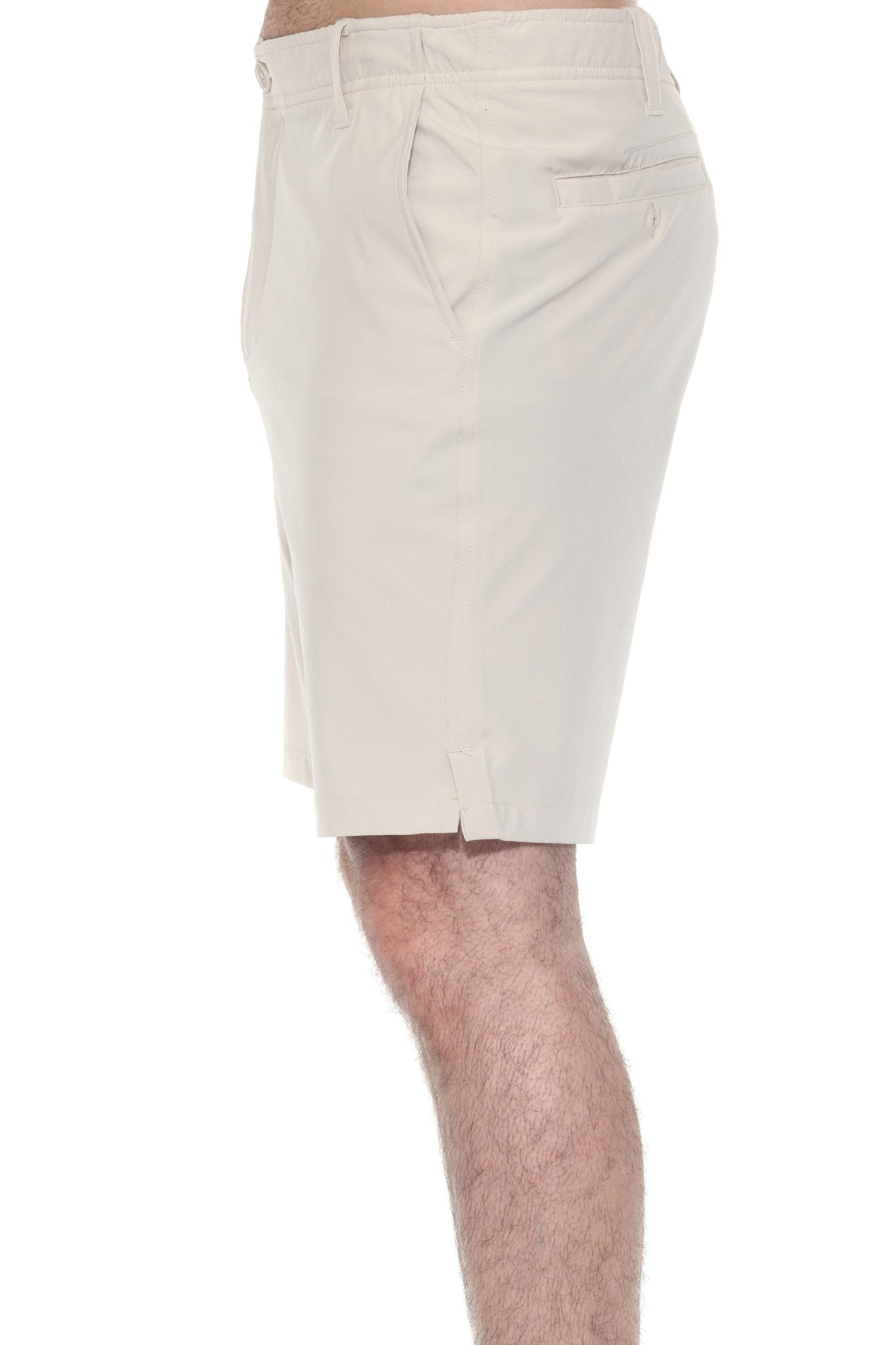 Side view of a person wearing the Men’s Dri-Fit Stretch Performance Shorts in beige, showing pocket detail.