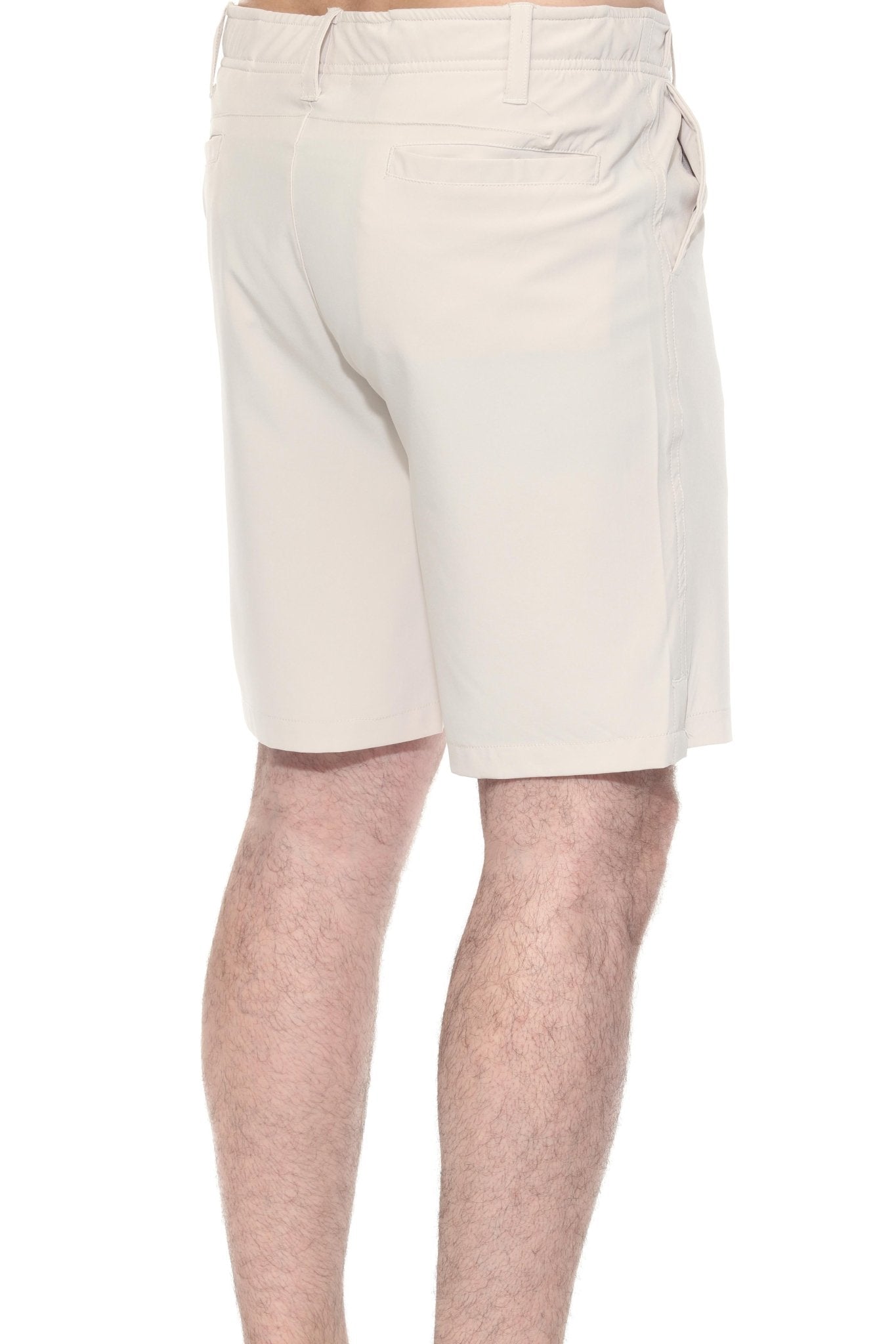 Rear view of a man wearing tan Men’s Dri-Fit Stretch Performance Shorts.