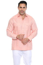 Men's salmon linen embroidered guayabera long sleeve, front view adjusting the barrel cuff, studio white background
