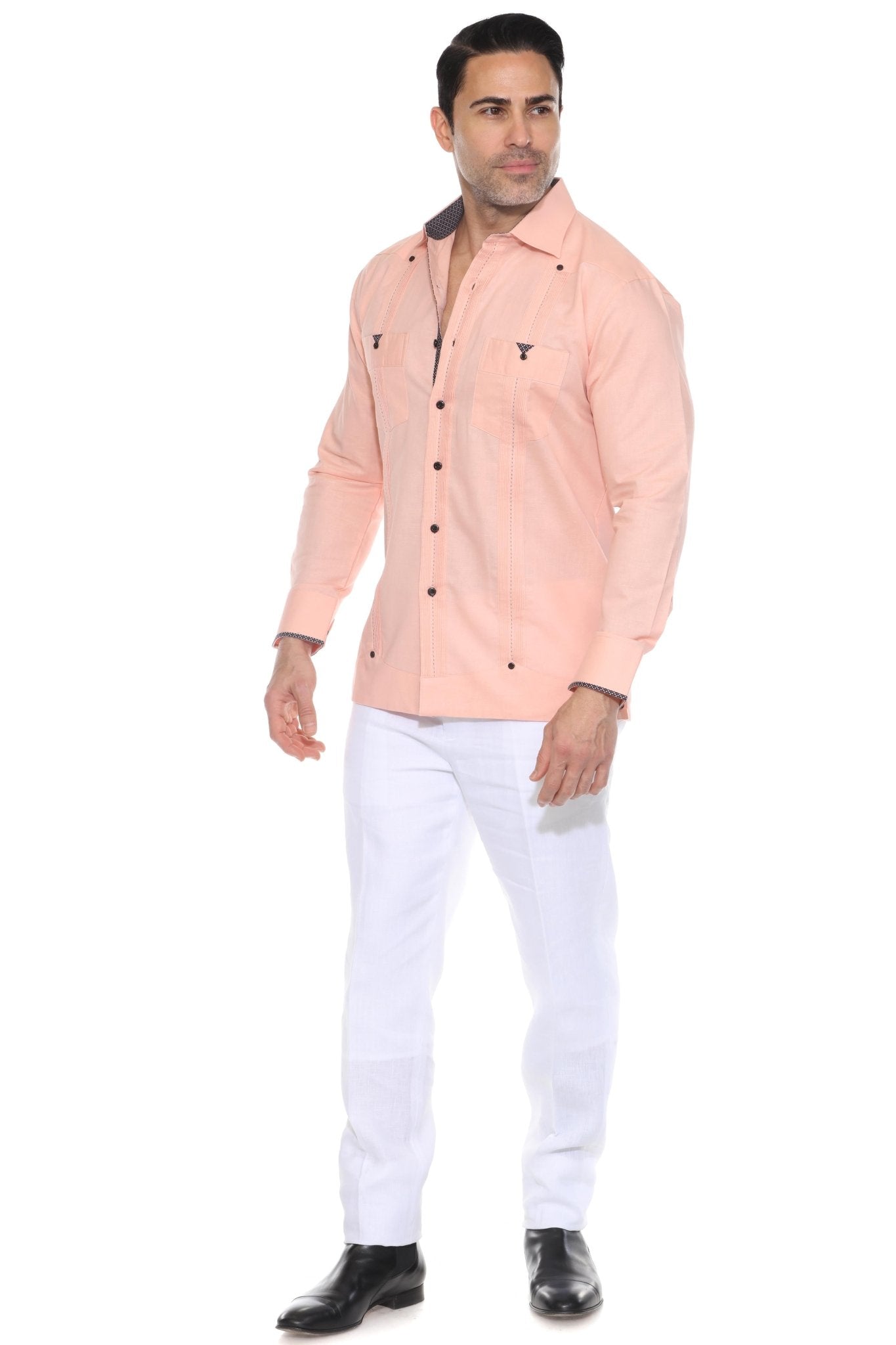 A full-body angled view of the peach linen guayabera shirt for men, highlighting the lightweight 100% linen construction and stylish printed trim accents.