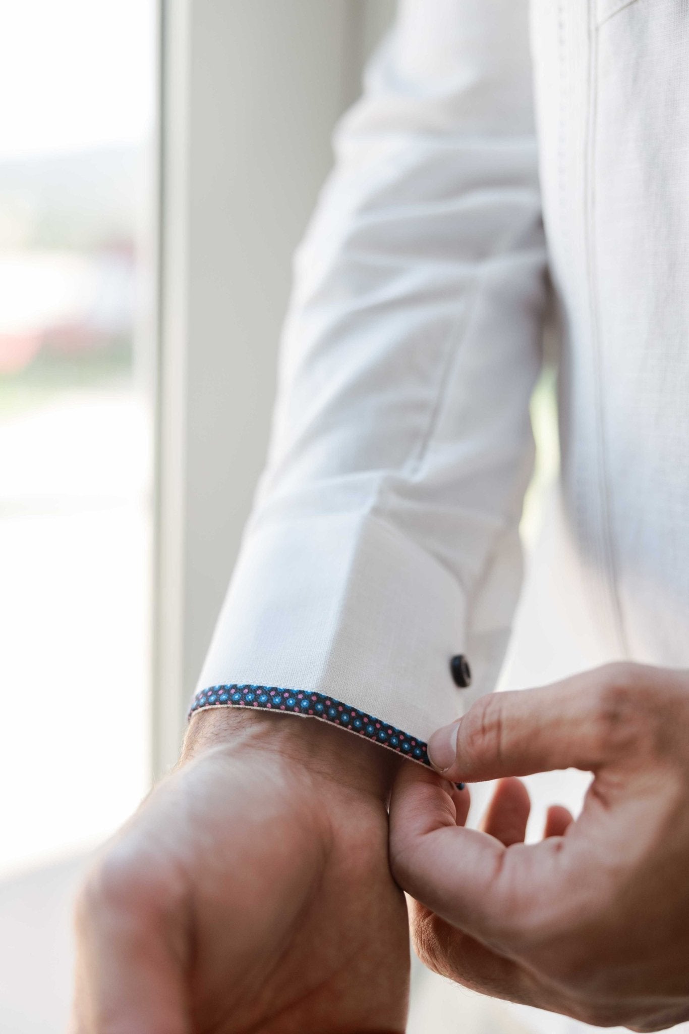 Close-up of the sleeve cuff on a Men's Long Sleeve Linen Guayabera Shirt, featuring the unique blue printed trim accent.