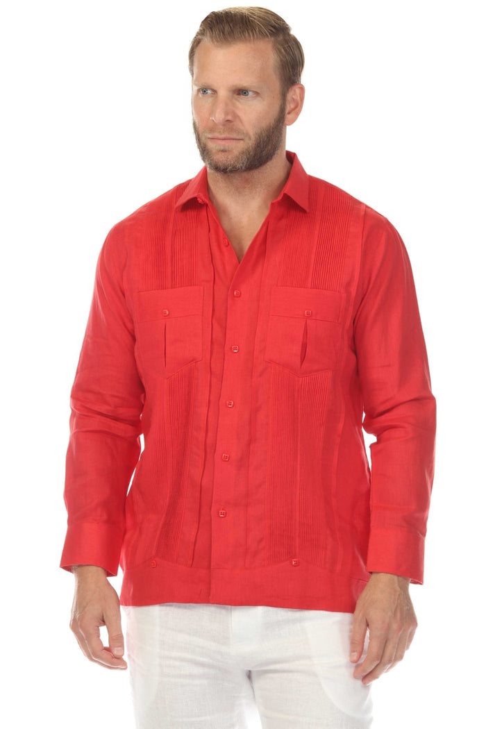 Man wears a red Yarn Dyed Linen Guayabera shirt with multi-pleats and two pockets, and white pants.
