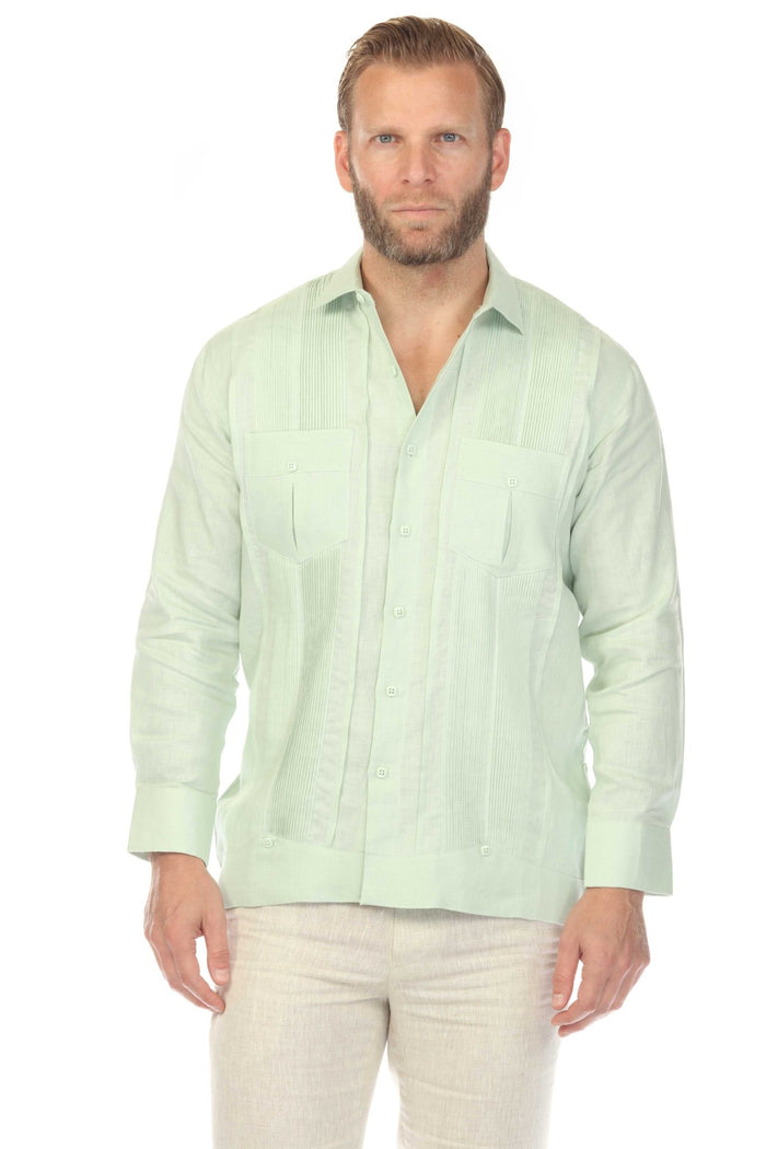 Man wears a red Yarn Dyed Linen Guayabera shirt with multi-pleats and two pockets, and white pants.