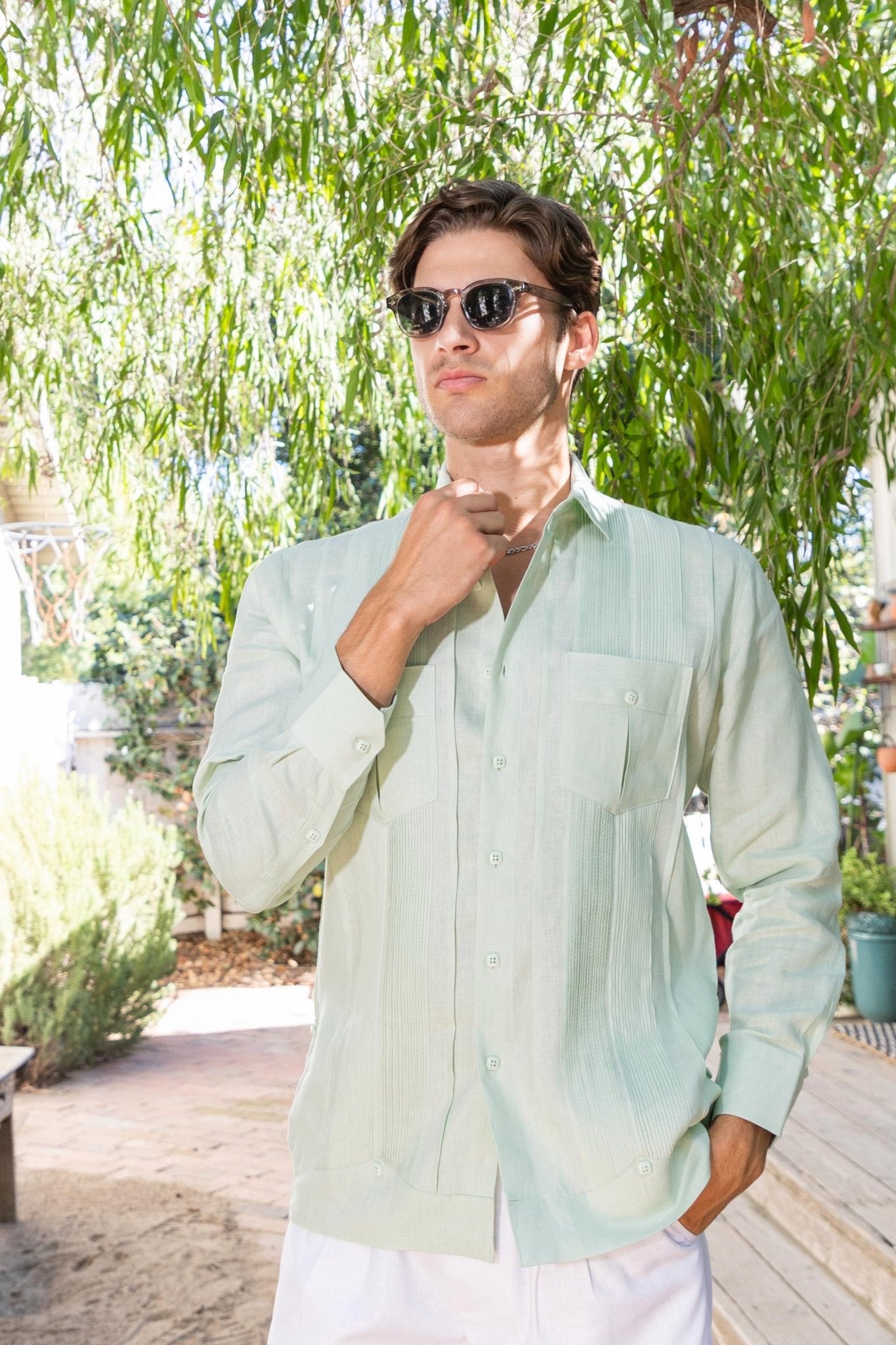 Man wearing a light green "Yarn Dyed Linen Guayabera" shirt with multi pleats and two pockets.