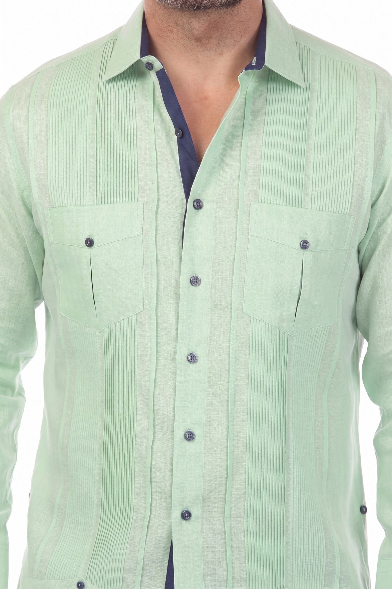 Close-up of the sage green 100% Linen Contrast Panel Guayabera Shirt with long sleeves and navy contrast trim.