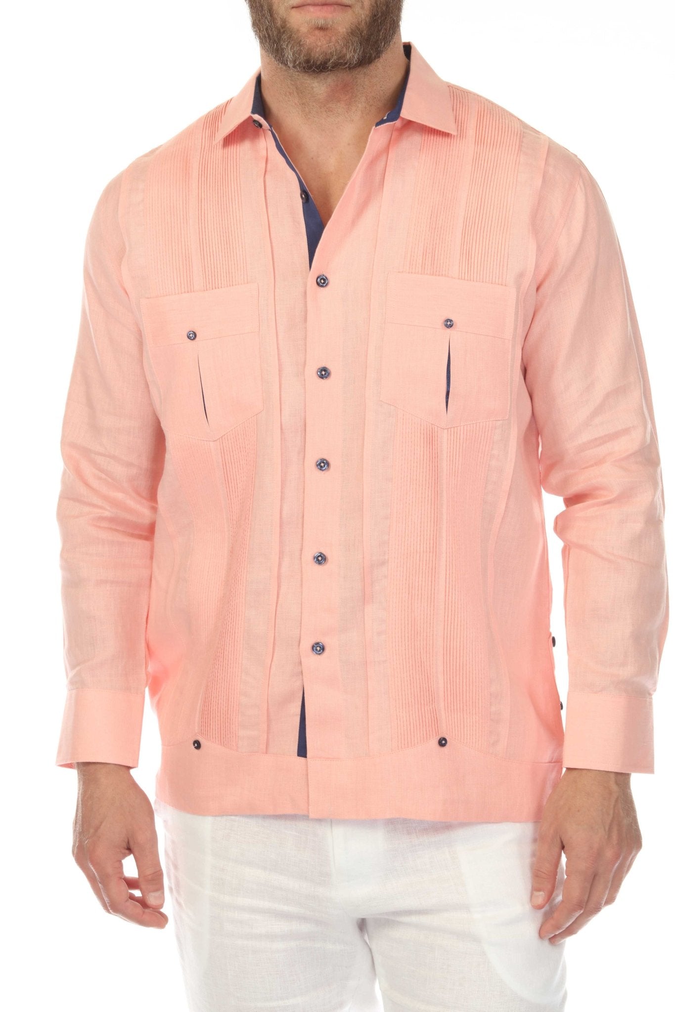 Close-up front view of men's salmon linen guayabera shirt highlighting two chest pockets with navy contrast trim and pleated bib detail, studio white background