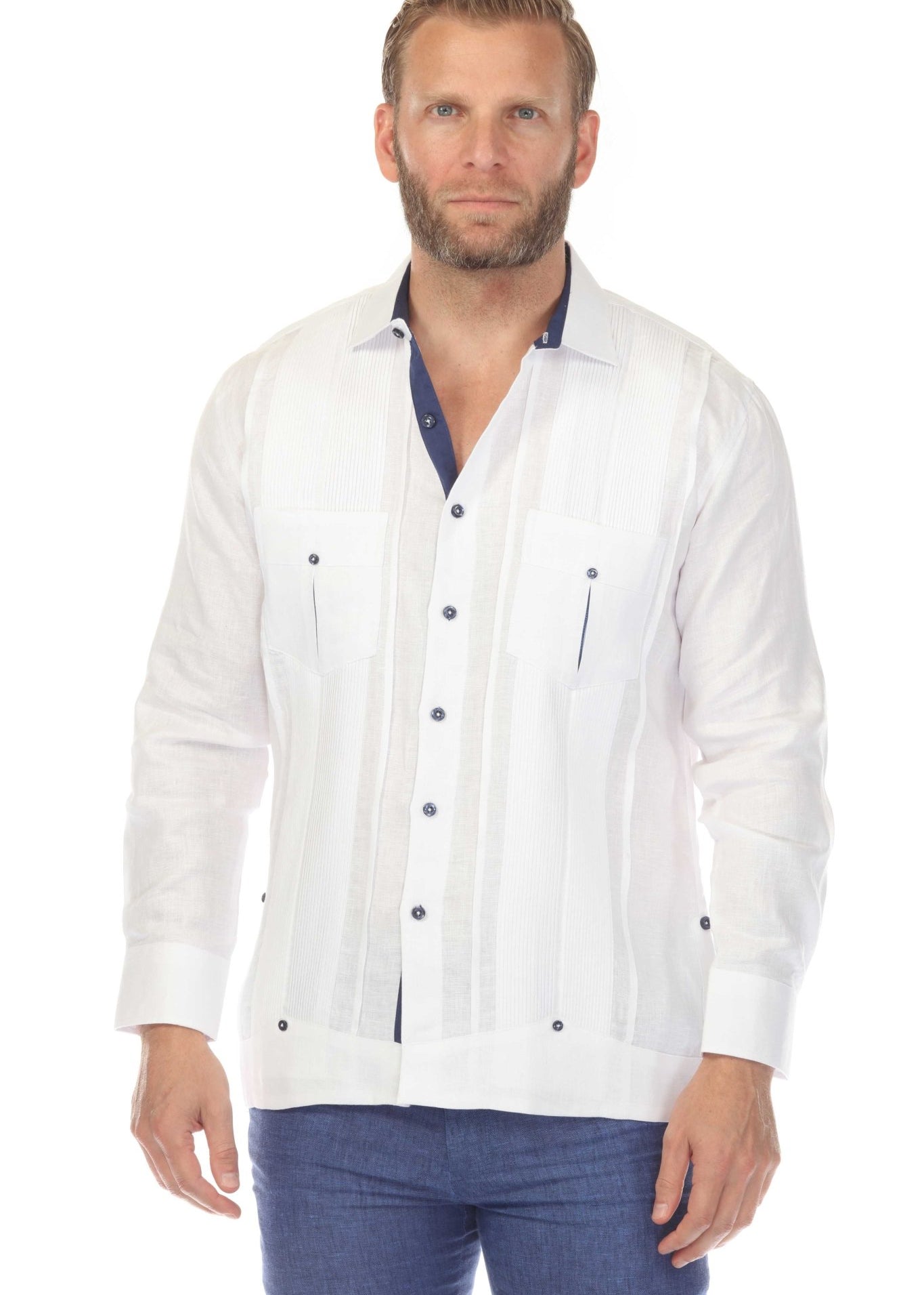 Men's long sleeve white linen guayabera shirt half-body front view, navy collar and chest pockets visible, styled with blue denim on clean white background