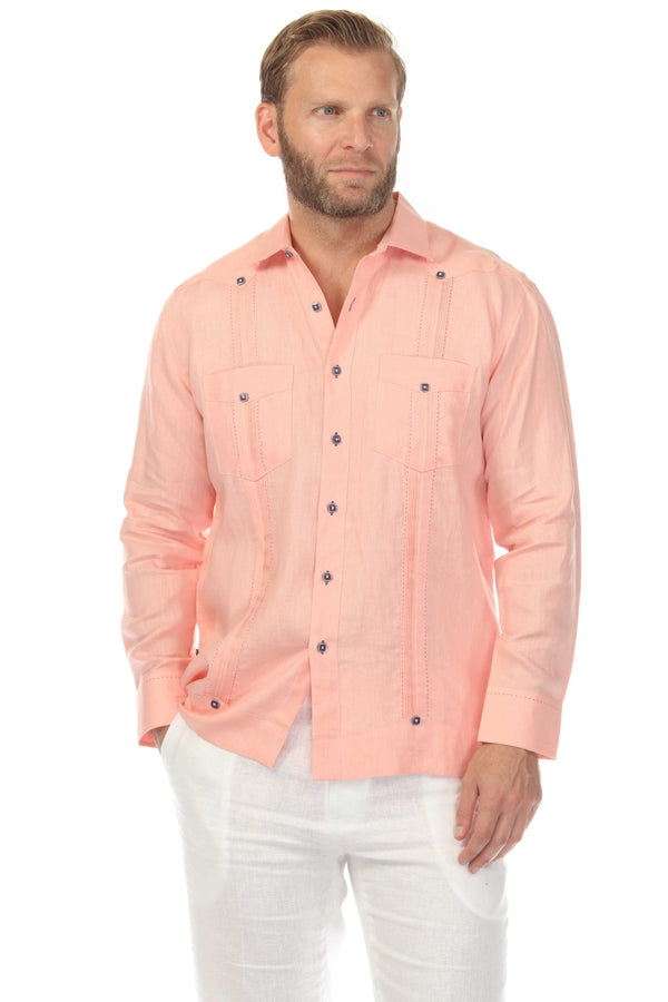Man wears a salmon-colored 100% Linen Contrast Panel Guayabera Shirt Long Sleeve with white pants.